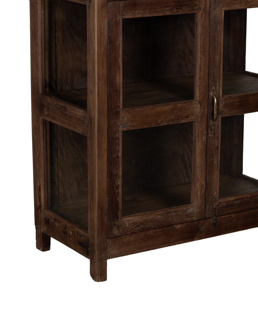 Vintage Indian oak wood cabinet, close-up of glass paneled door and bronze handle.