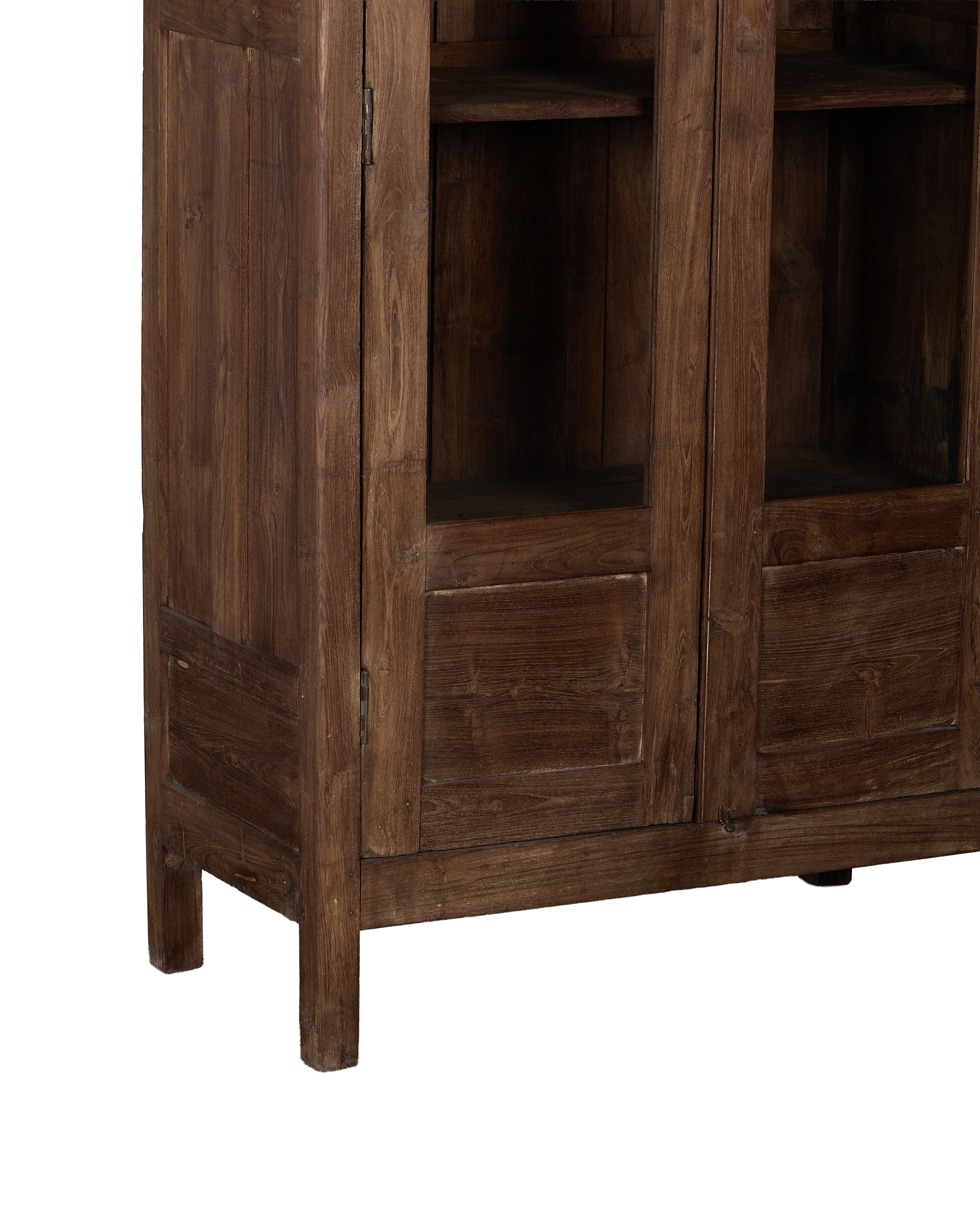 Vintage Indian oak cabinet: lower right corner showing aged natural wood, recessed panels, and short leg.