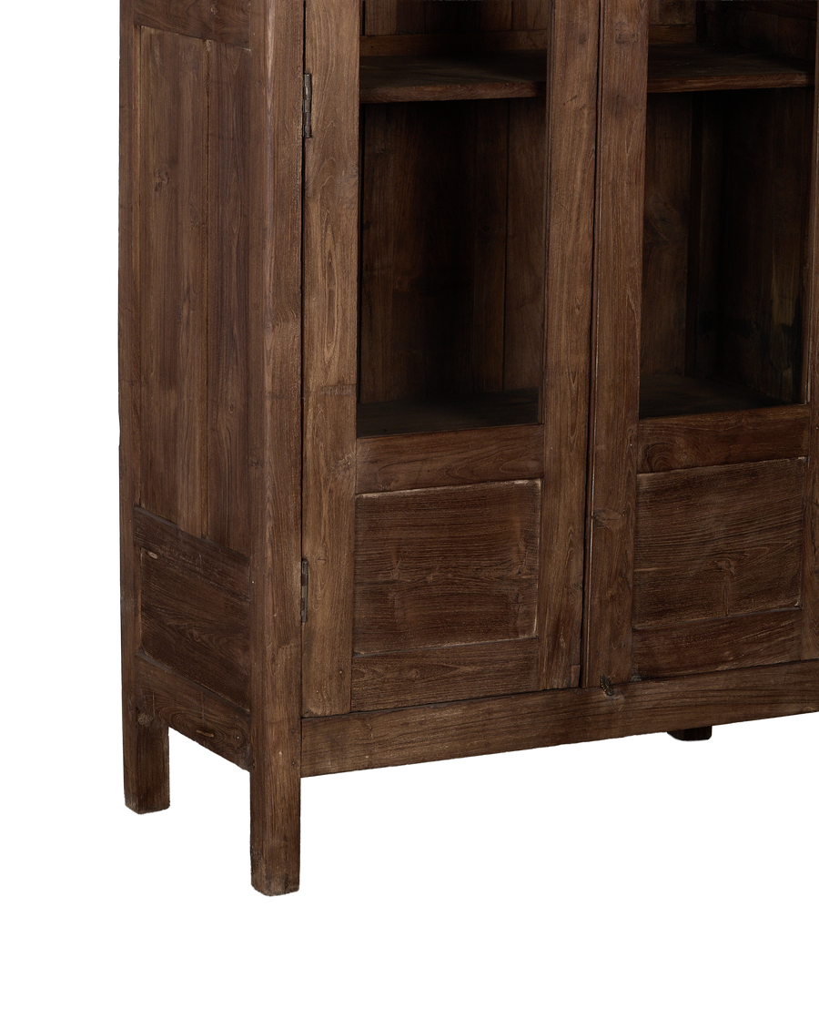 Vintage Indian oak cabinet: lower right corner showing aged natural wood, recessed panels, and short leg.