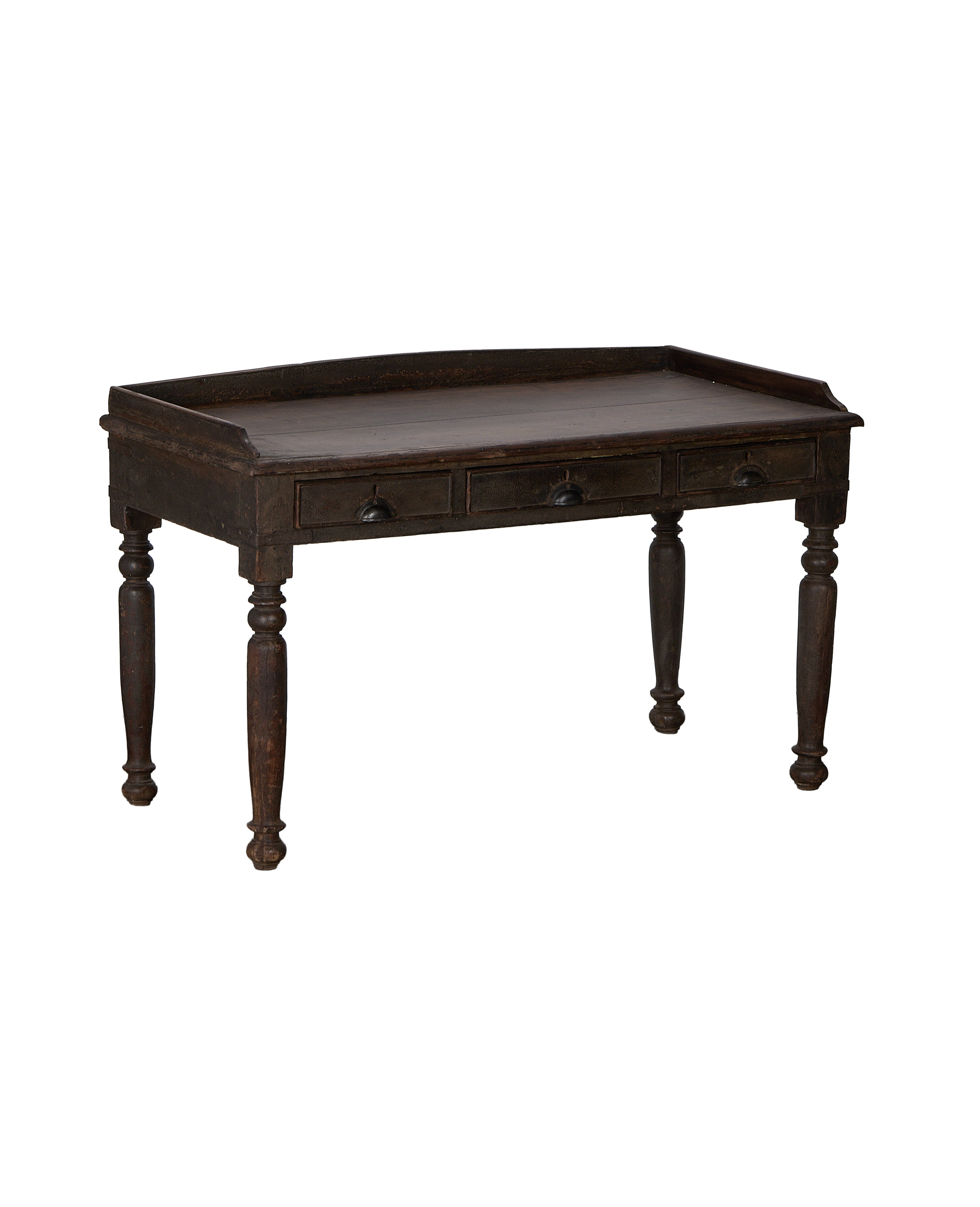 Dark vintage oak wood desk from India, showing three drawer fronts, turned legs.