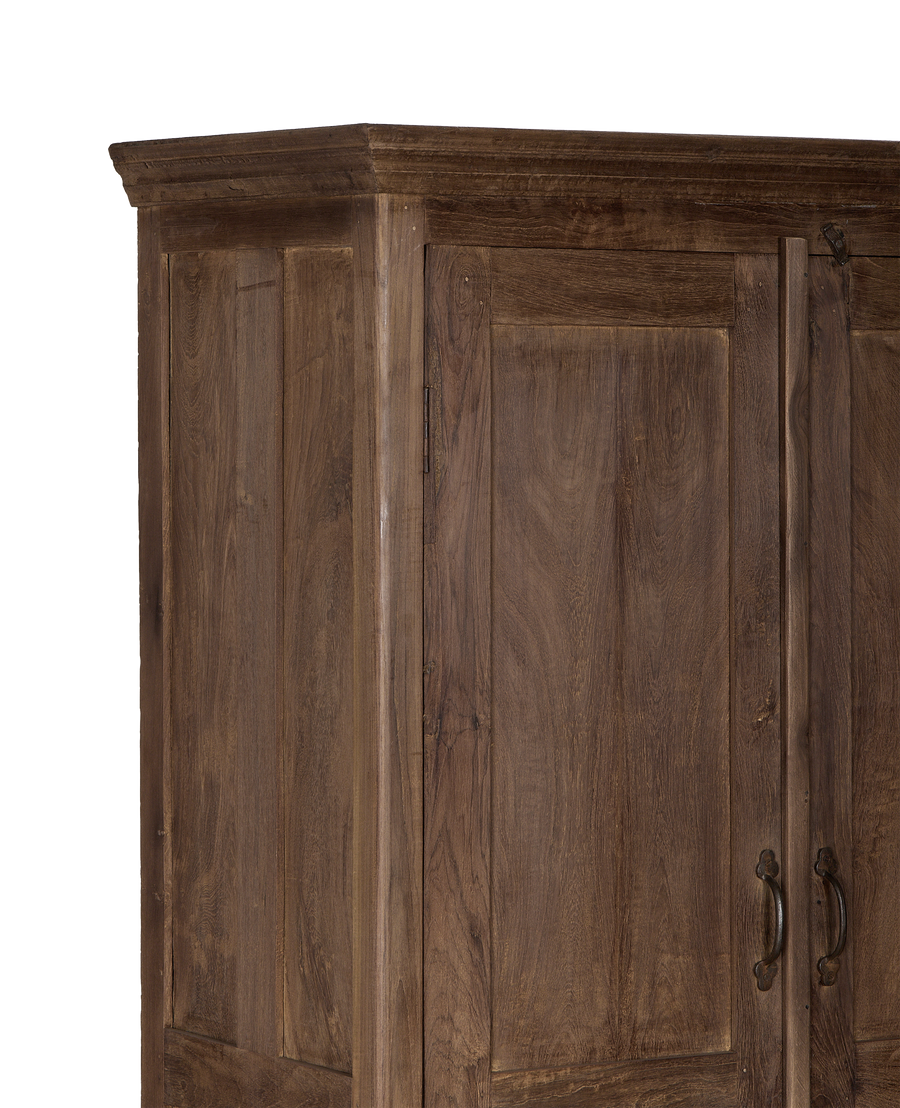 Close-up of vintage Indian oak wood cabinet's door panel and metal handles.