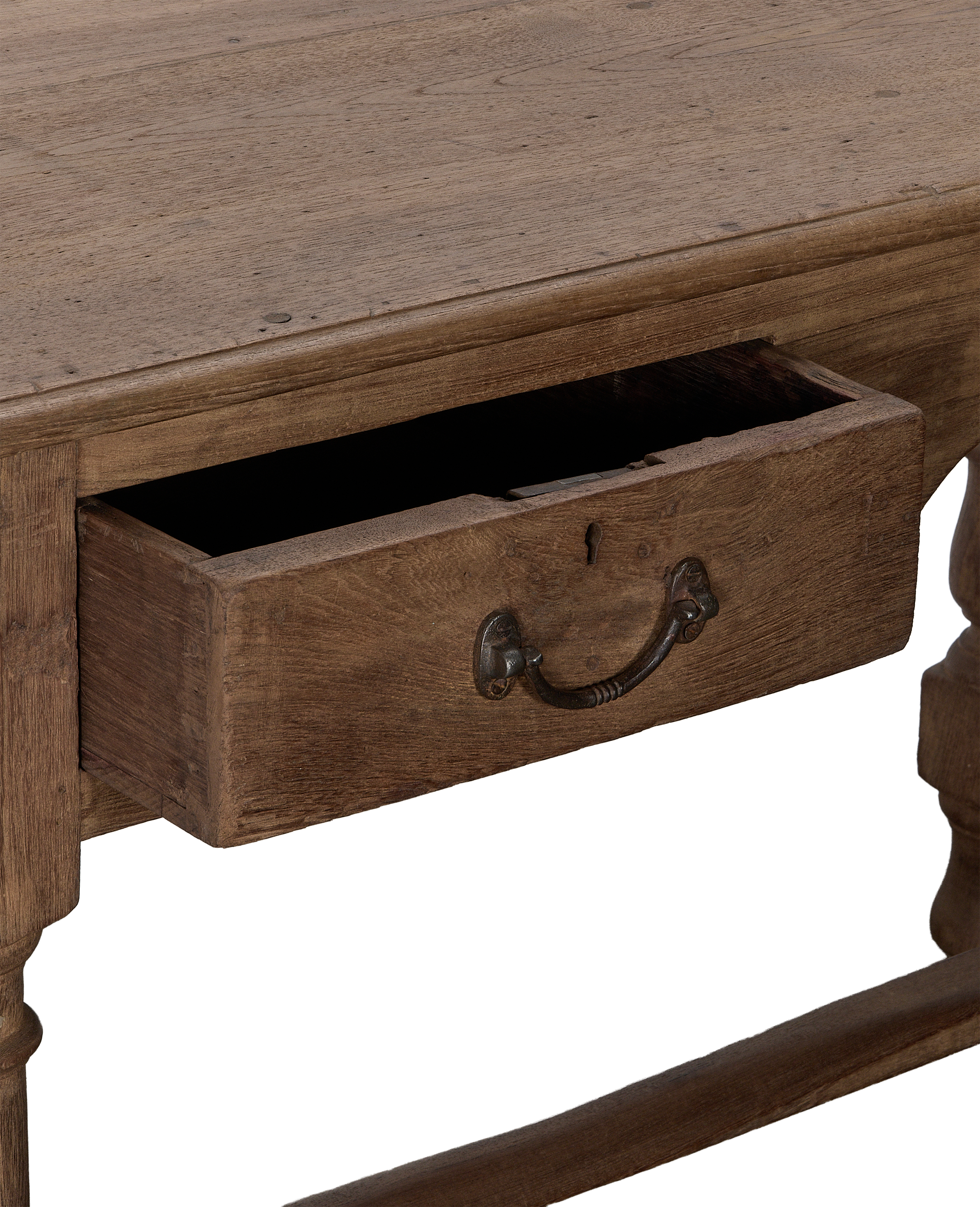 Vintage Indian oak desk with open drawer, detailed antique metal handle, natural wood finish.