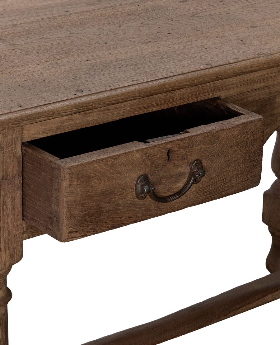 Vintage Indian oak desk with open drawer, detailed antique metal handle, natural wood finish.