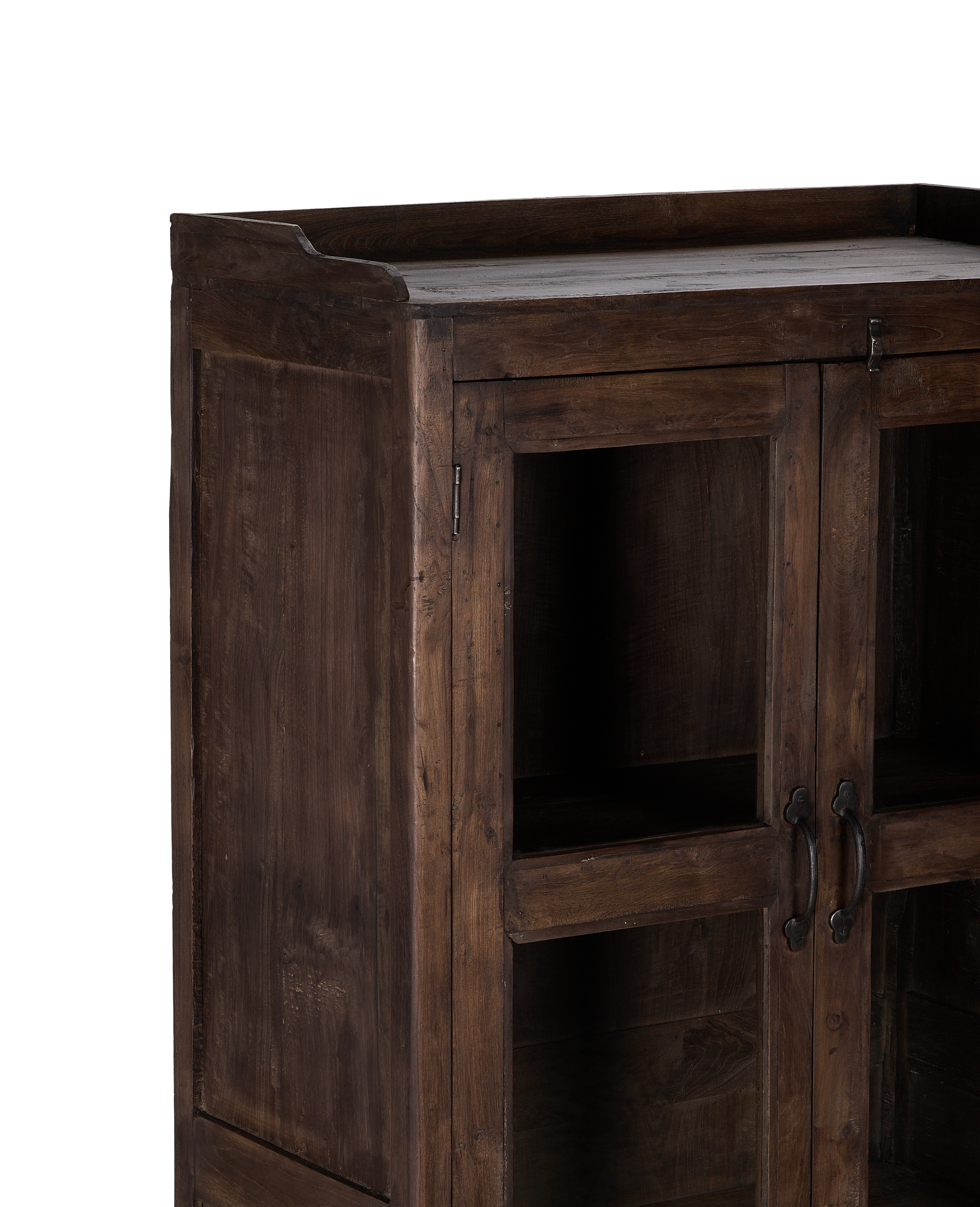 Angled view of vintage Indian oak wood cabinet, showcasing distressed finish and glass doors.