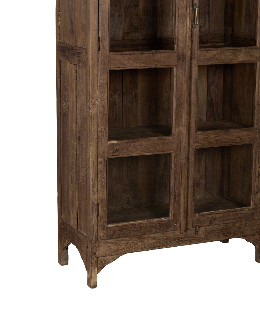 Vintage Indian oak cabinet featuring natural wood grain, glass panels, brass hardware, and arched legs.