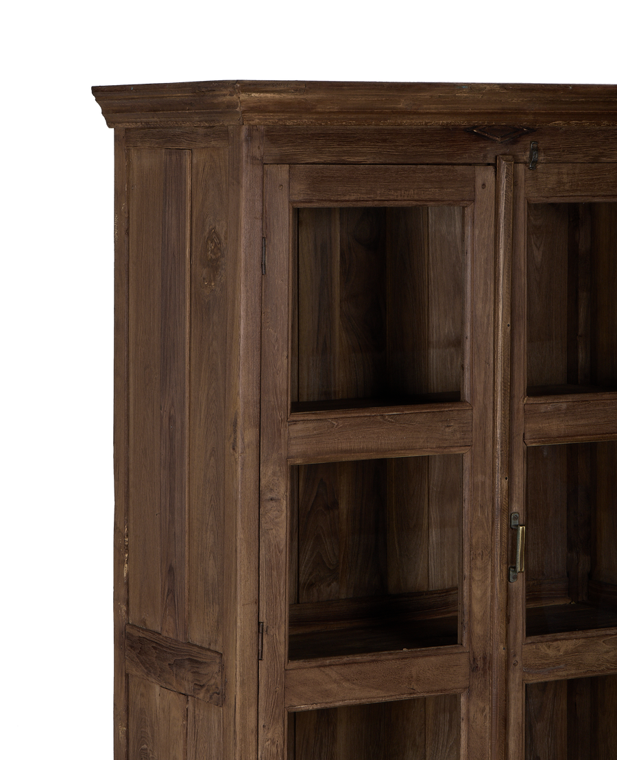 Close-up of vintage Indian oak wood cabinet's natural grain and glass door detail.