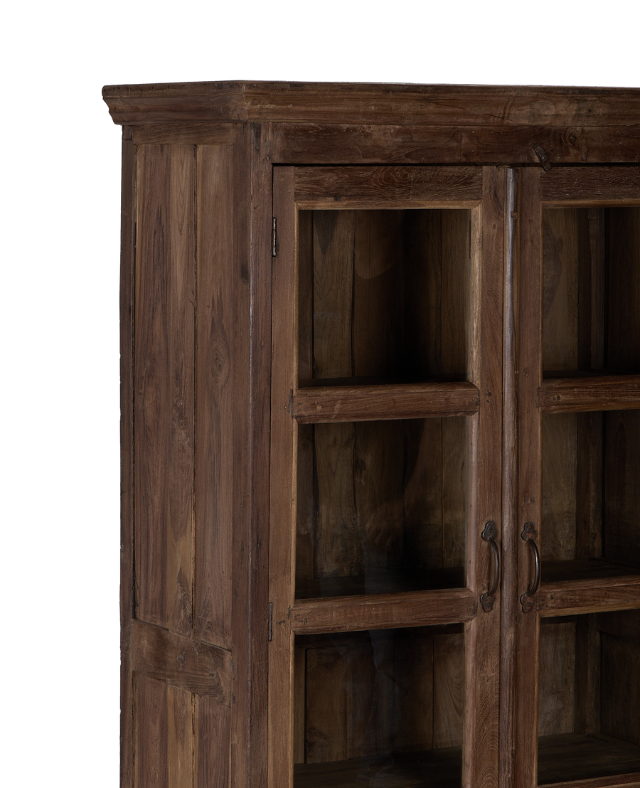 Vintage Indian oak wood cabinet, close-up of glass doors with distressed finish.