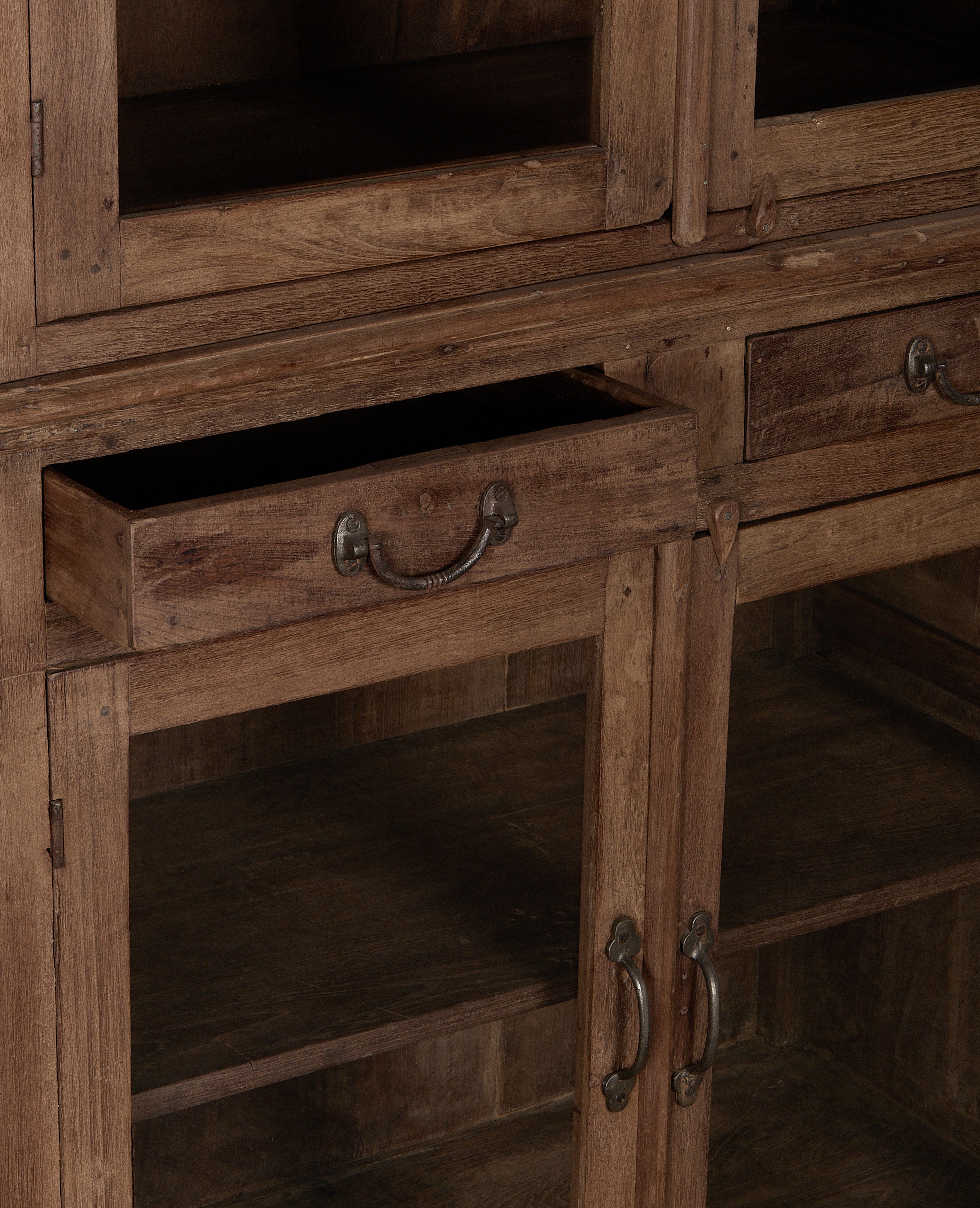 Opened vintage oak cabinet drawer from India, displaying natural wood grain.