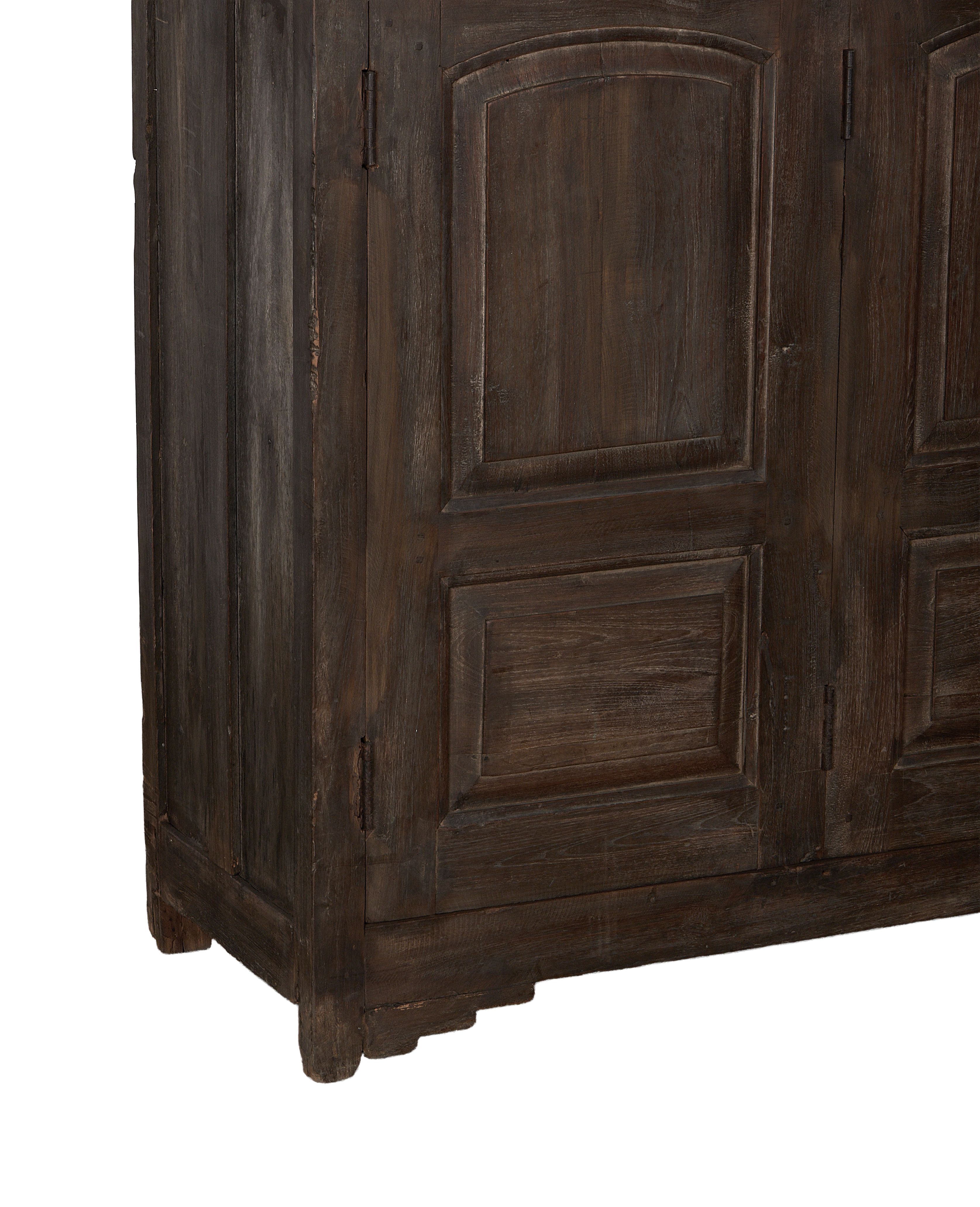 Vintage dark oak sideboard, showing intricate paneling details, visible hinge, and aged natural wood texture.