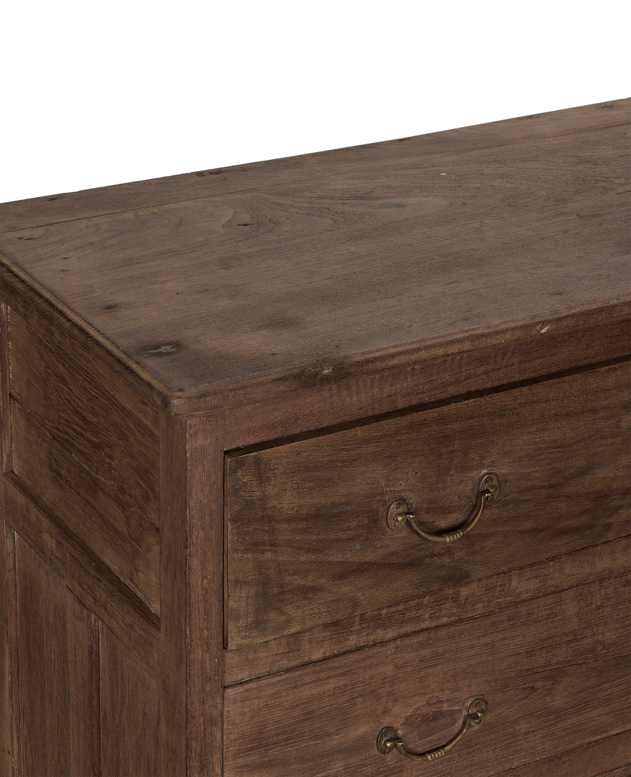 Vintage oak dresser, angled close-up revealing natural wood grain, ornate brass handle.