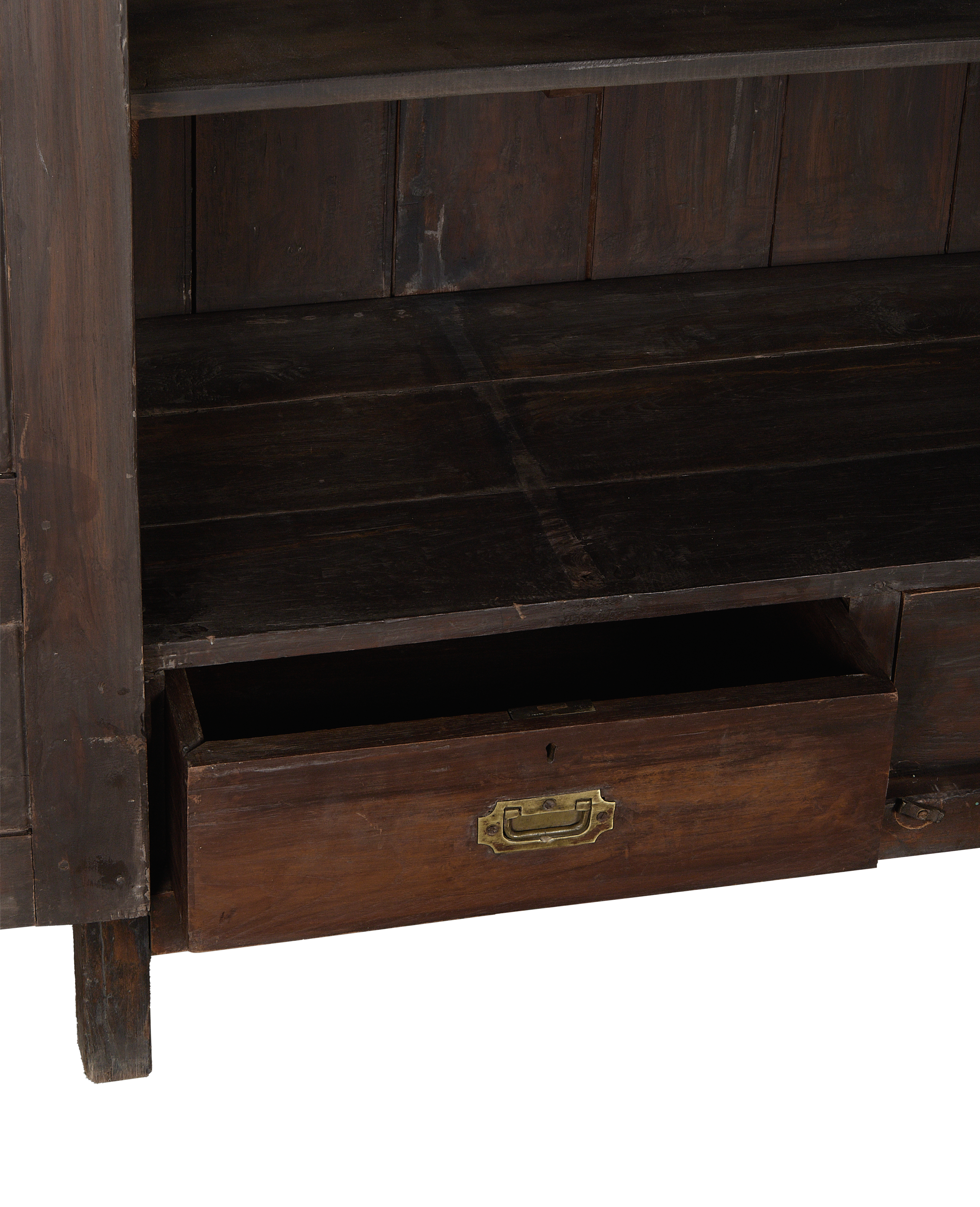 Open drawer of vintage Indian oak wood cabinet with brass pull detail.