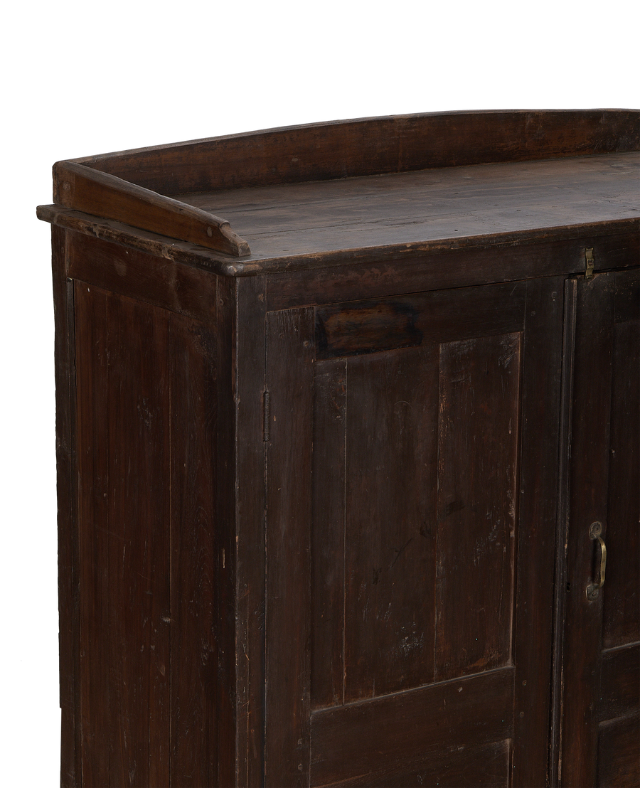 Close-up side view of vintage Indian natural oak cabinet, showing worn wood grain.