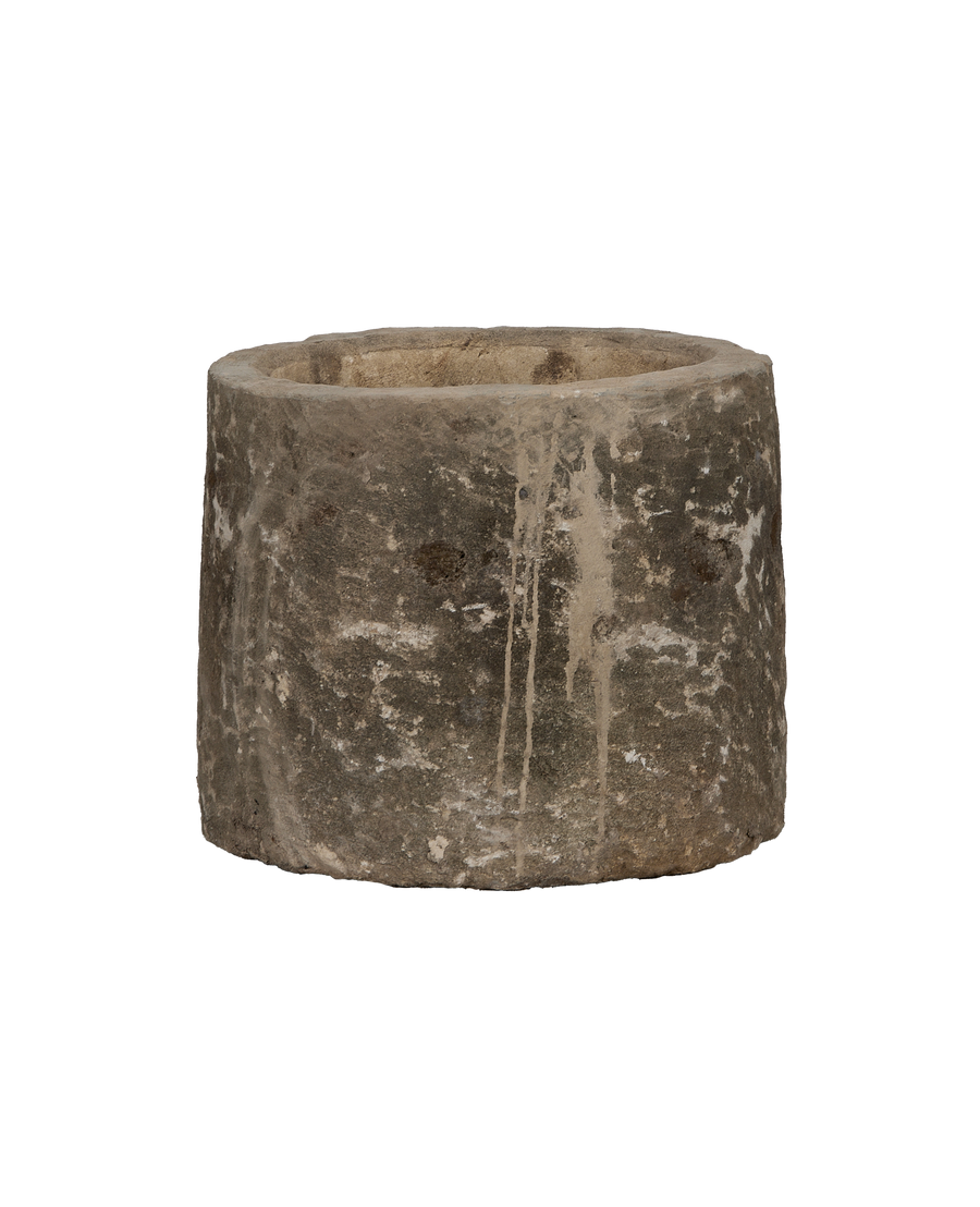 Vintage round limestone trough from Indonesia, showing rough exterior texture with aged drips.