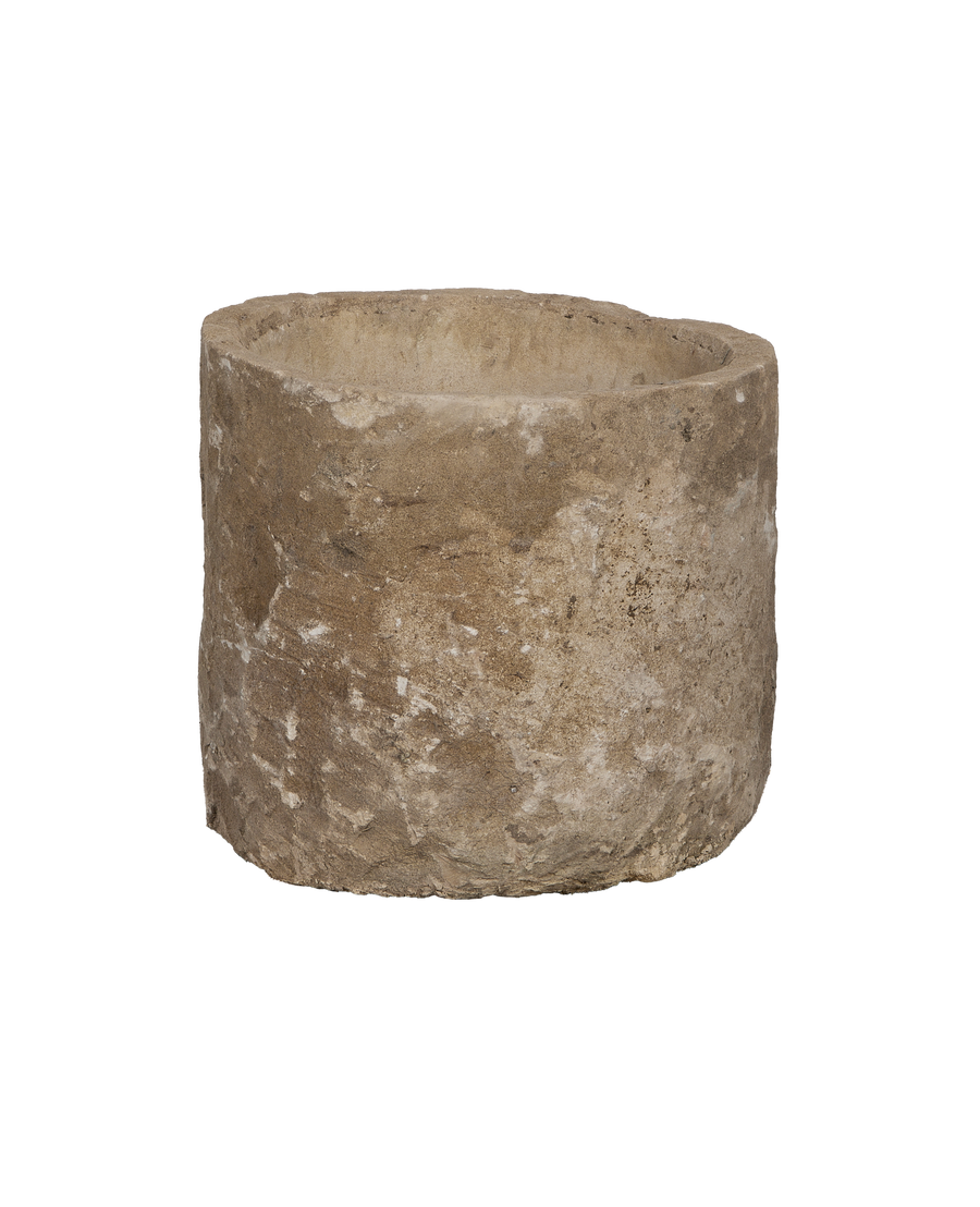 Round vintage Indonesian limestone trough, showing a rugged exterior texture and weathered surface.