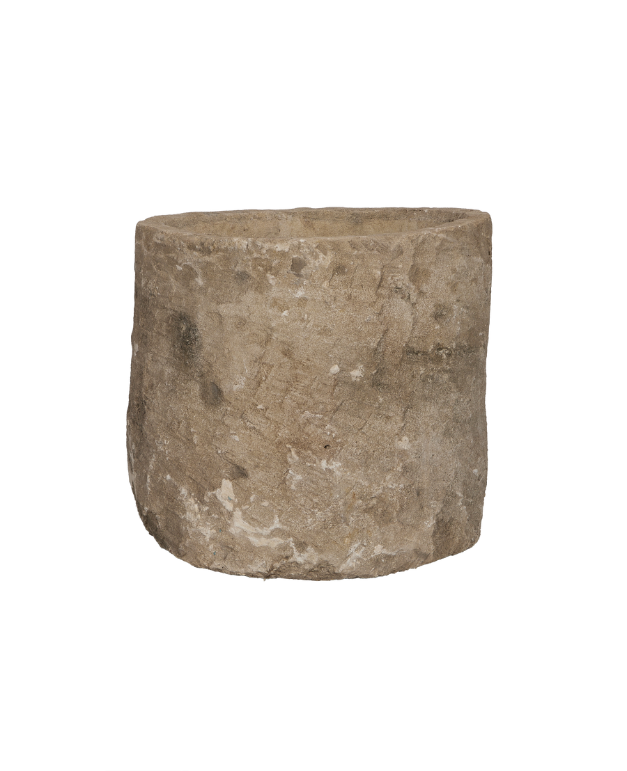 Vintage Indonesian round limestone trough, showing coarse textured surface detail.