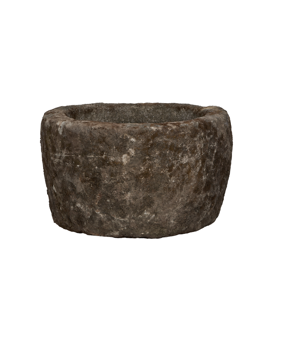 Vintage round limestone trough from Indonesia with textured, weathered surface showing its age.