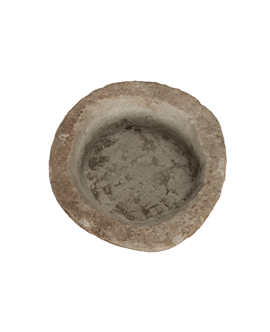 Vintage Indonesian limestone trough, top view reveals rustic, textured interior, round shape.