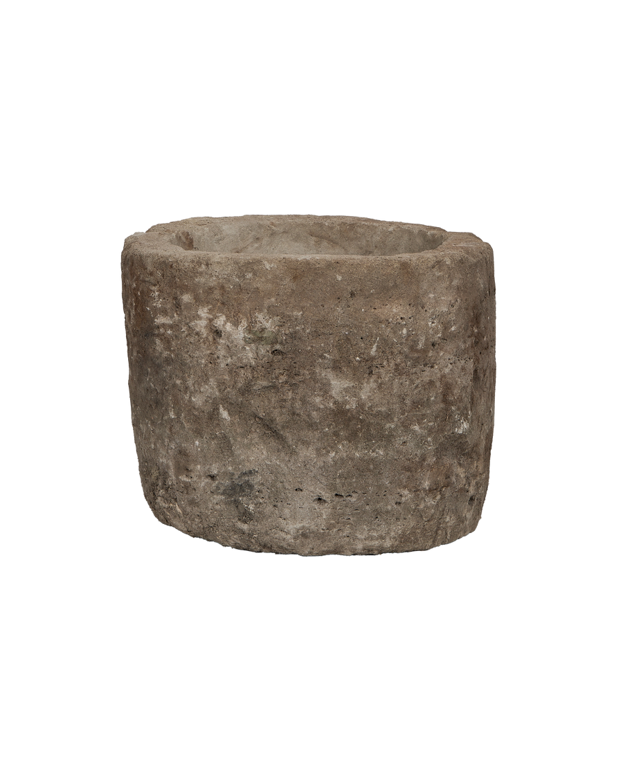 Vintage Indonesian round limestone trough, showing weathered texture from an elevated angle.