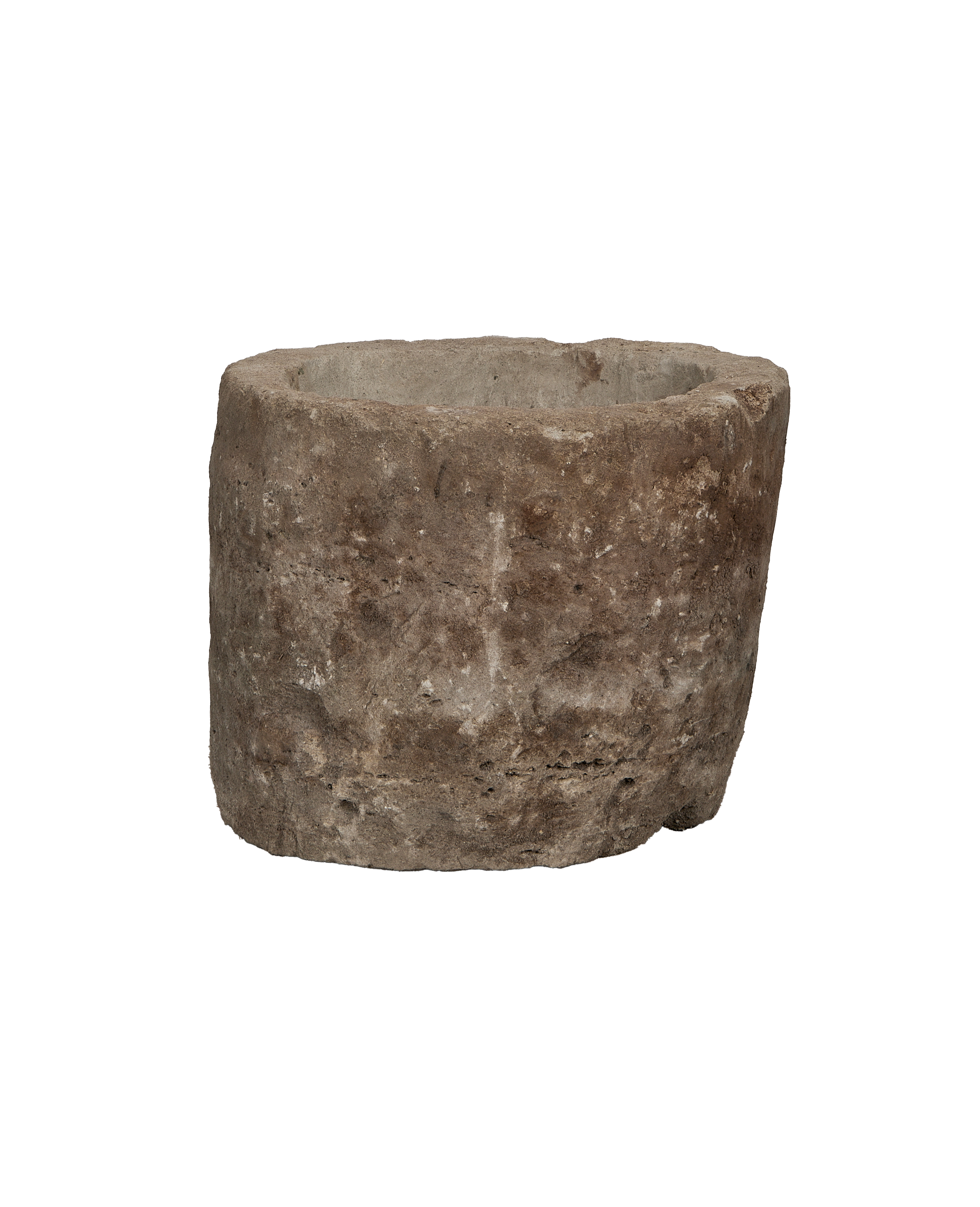 Vintage Indonesian round limestone trough, showing rugged texture and weathered gray surface.