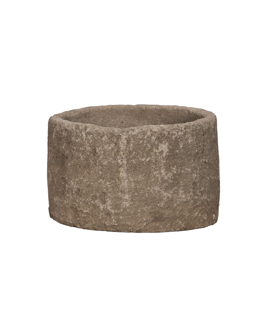 Vintage Indonesian round limestone trough, coarse texture, full front view.