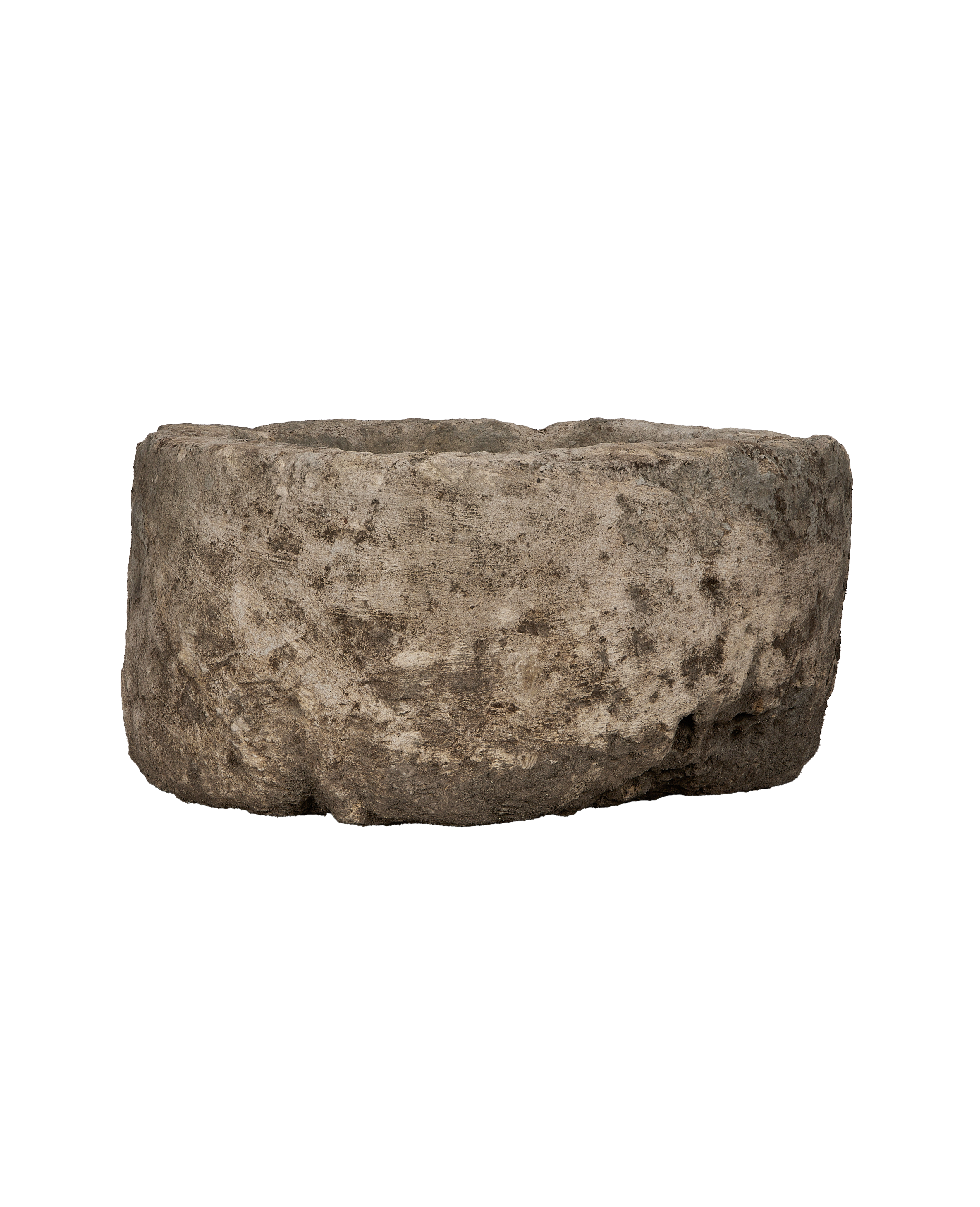 Vintage Indonesian round limestone trough, close-up of rough, weathered texture and organic shape.