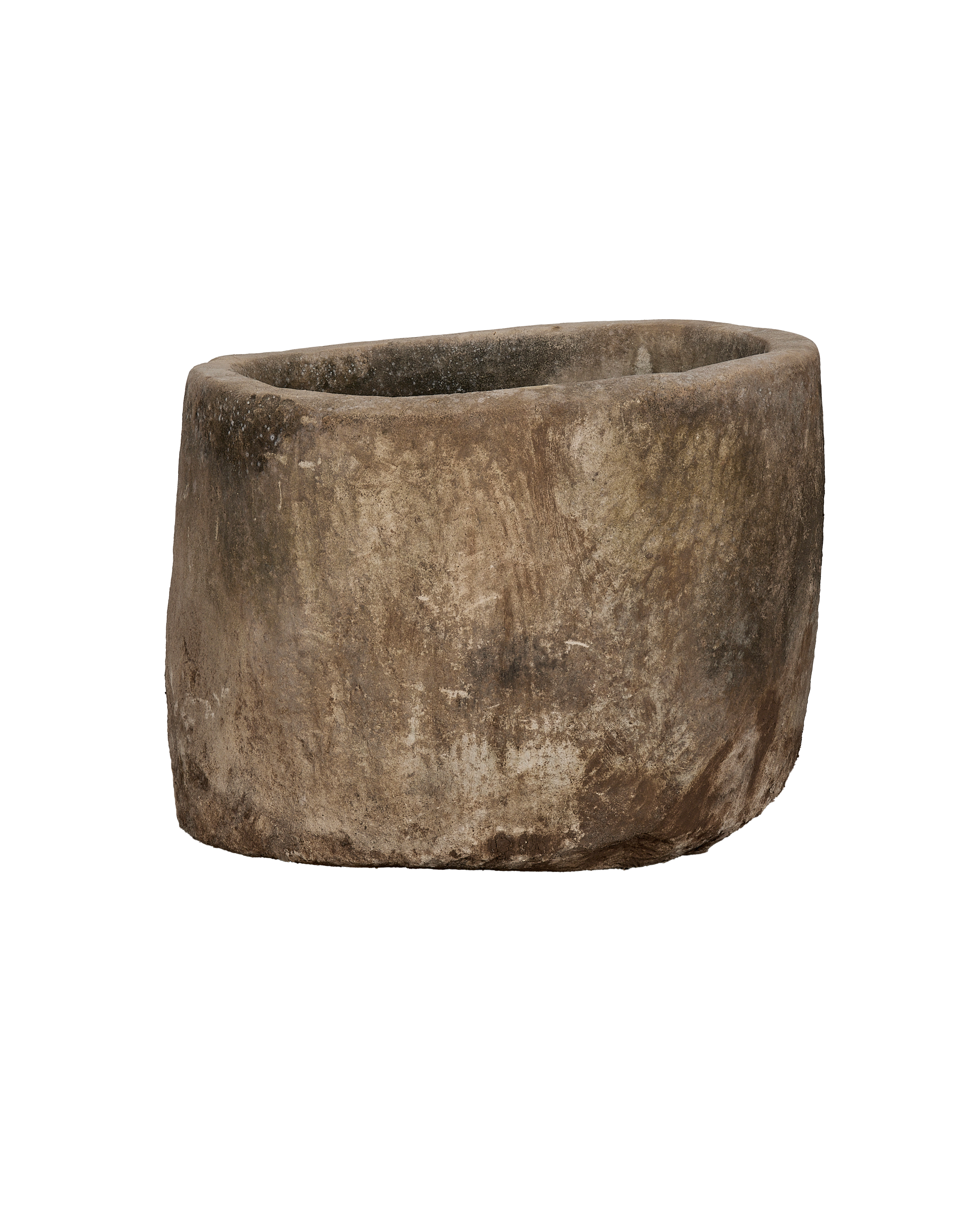 Vintage Indonesian limestone trough, showing its rough, weathered texture and rounded shape from a lower angle.