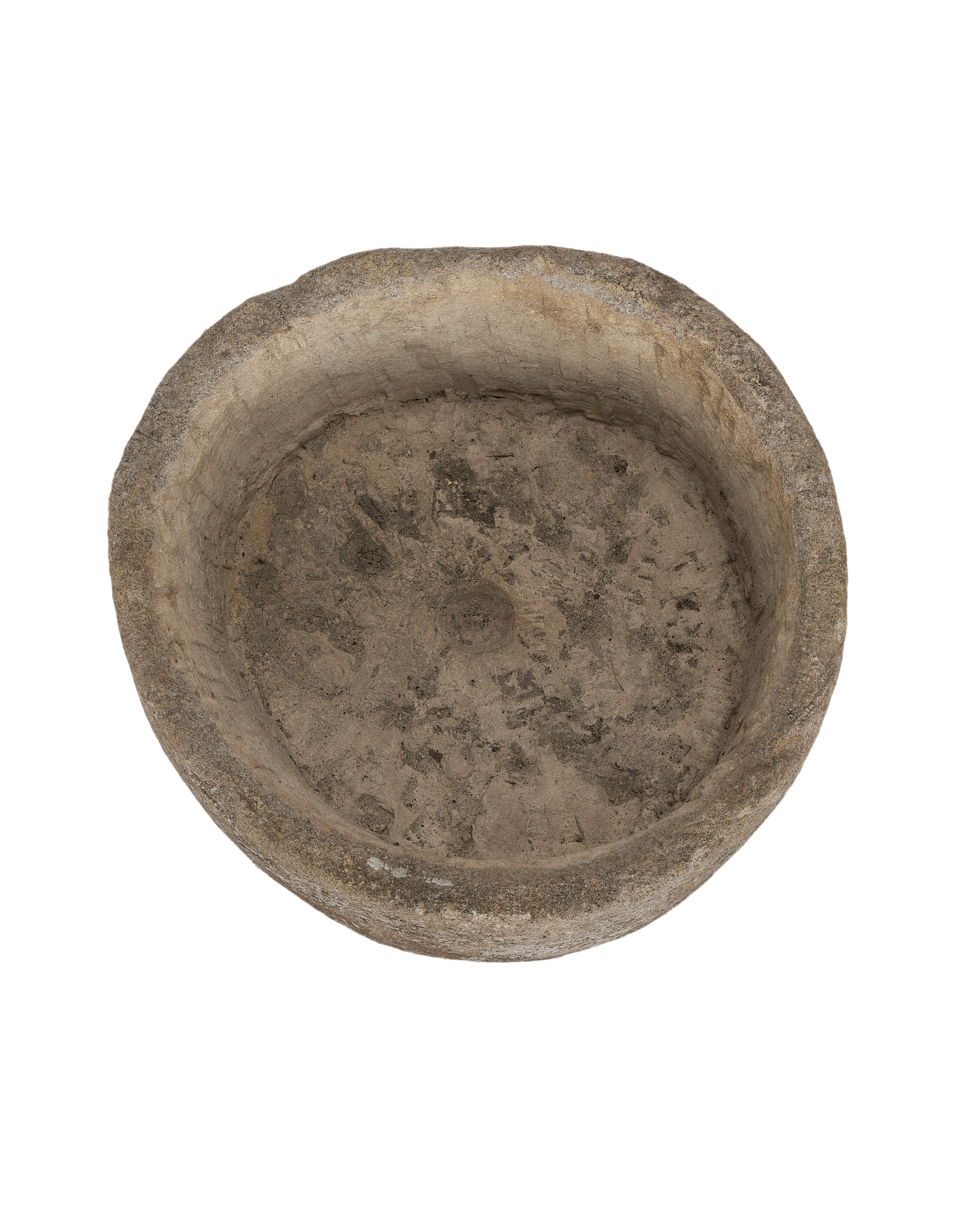Top-down view of a vintage round limestone trough with textured interior.