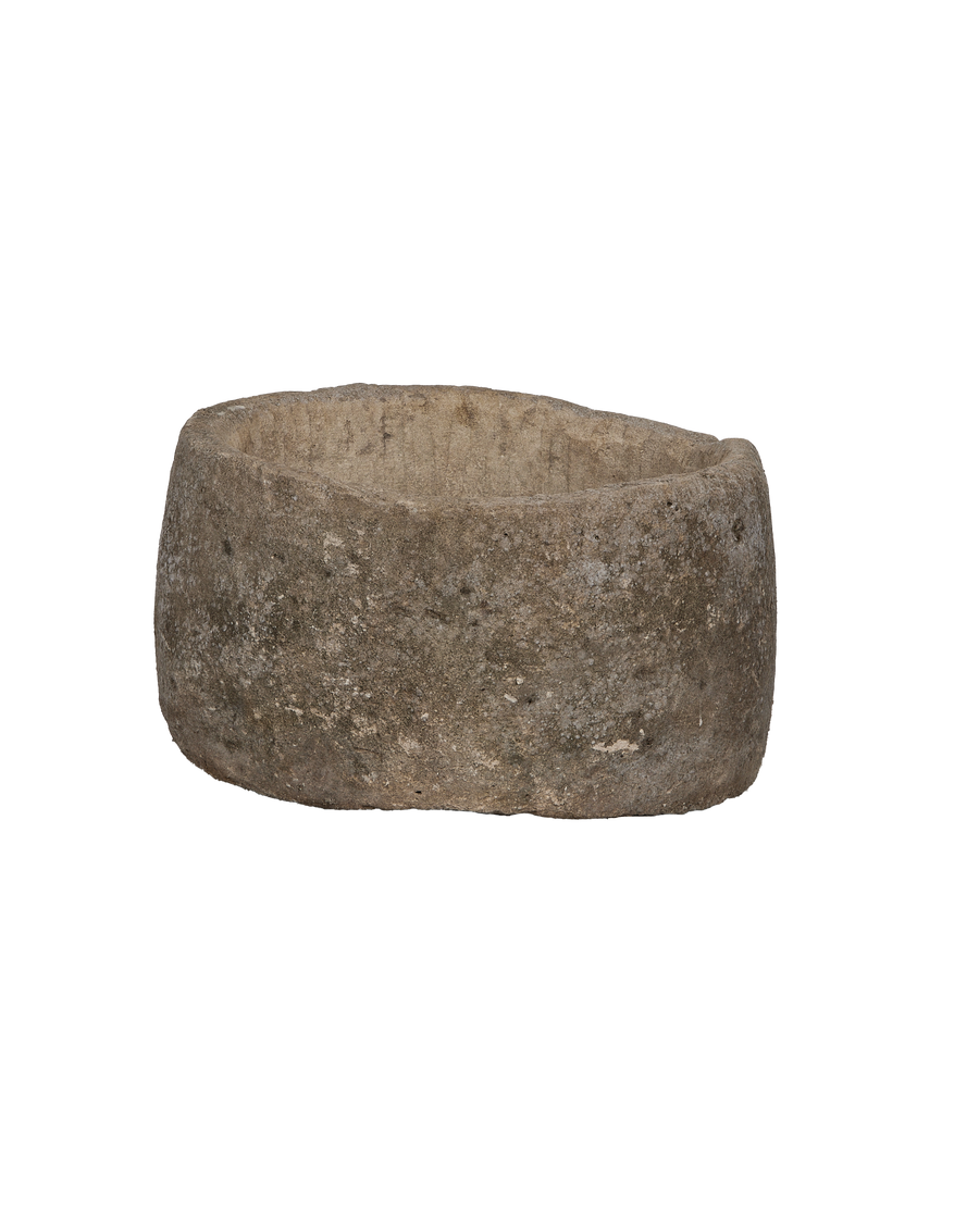 Vintage round limestone trough, Indonesian, weathered texture, upper-left view, rustic planter.