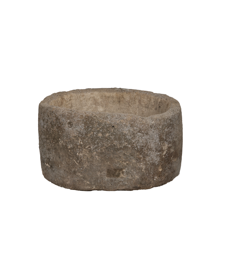 Vintage Indonesian round limestone trough, showing rough exterior texture and rim details.