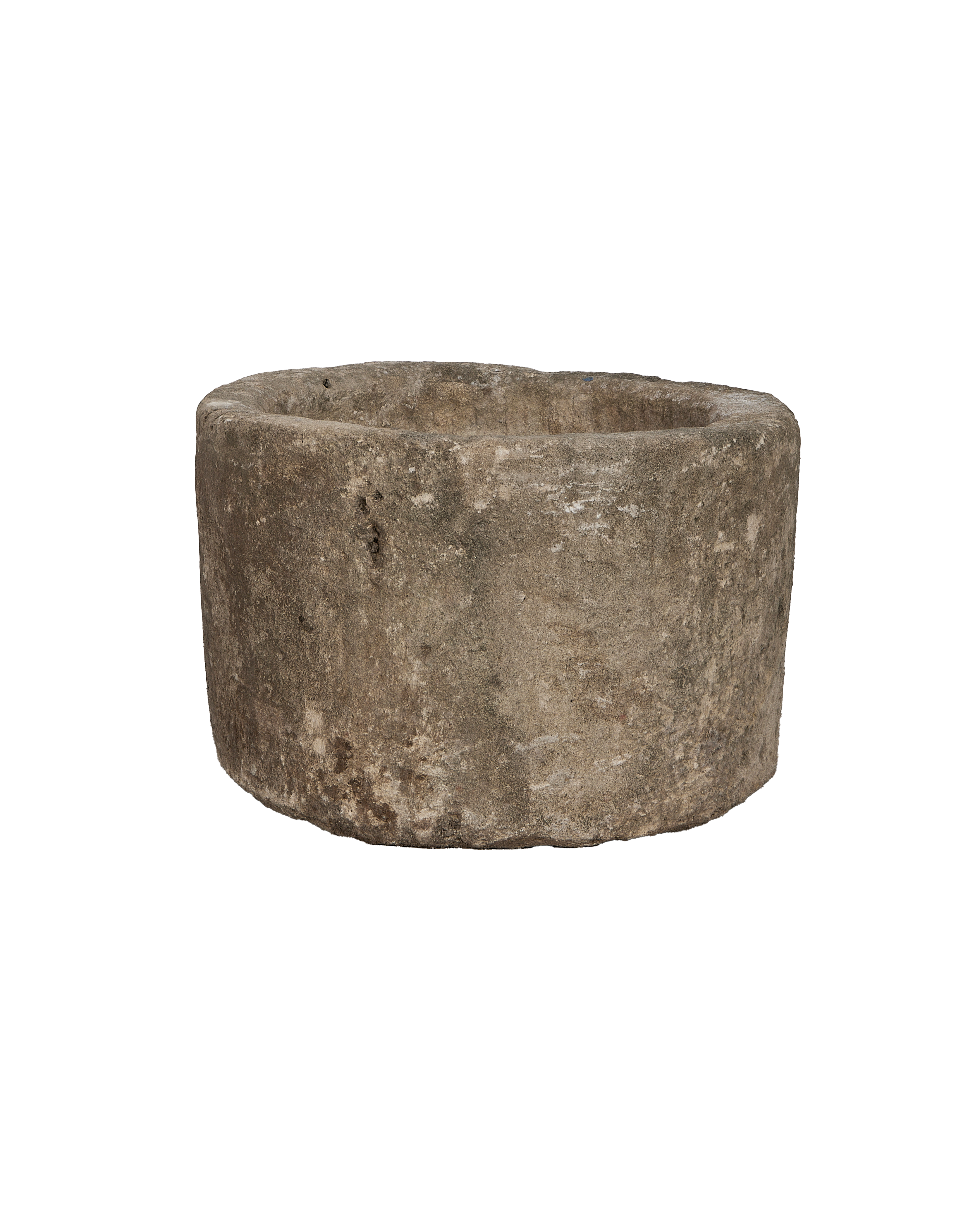 Vintage Indonesian round limestone trough, full side view showing rough texture.