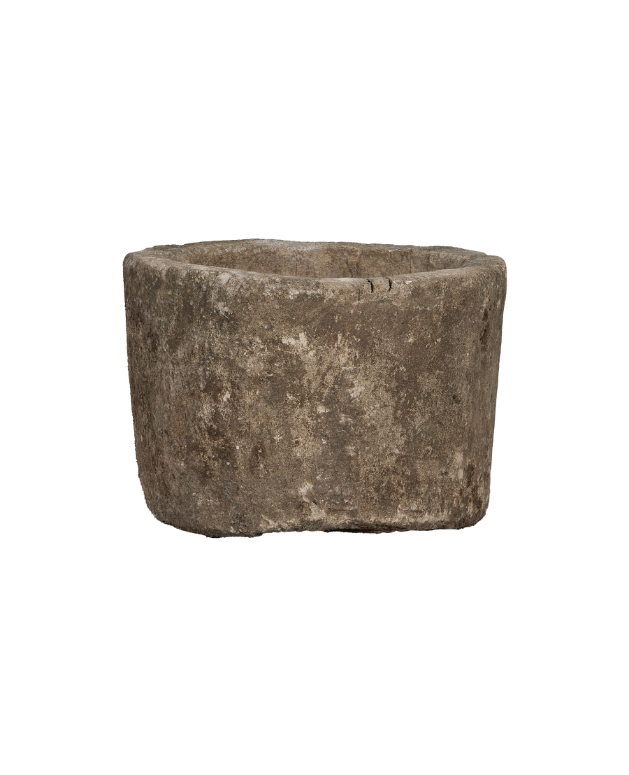 Vintage Indonesian round limestone trough, rich textured gray surface, full side view.