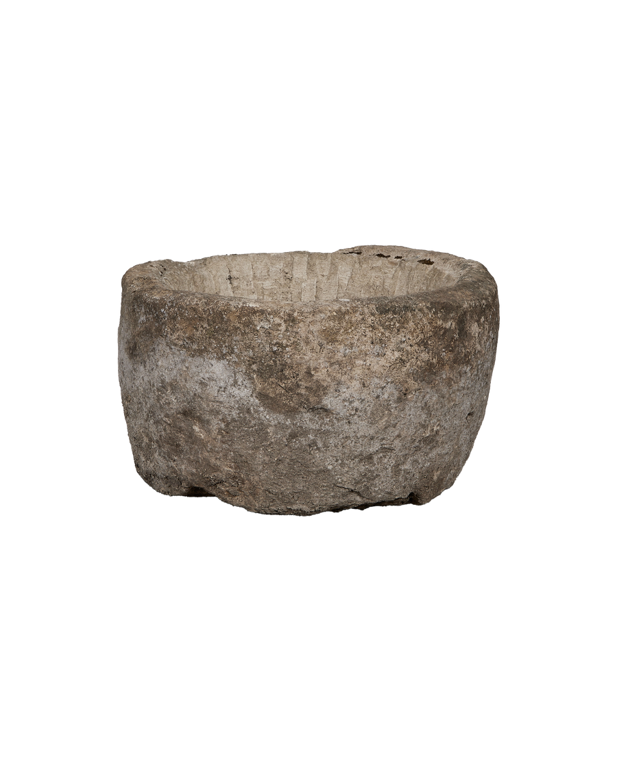 Vintage oblong limestone trough from Indonesia, viewed from side, highlighting weathered texture.