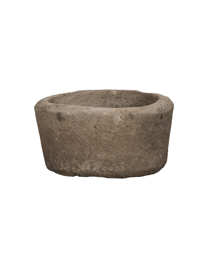 Vintage round limestone trough from Indonesia, showing rough texture and weathered finish.