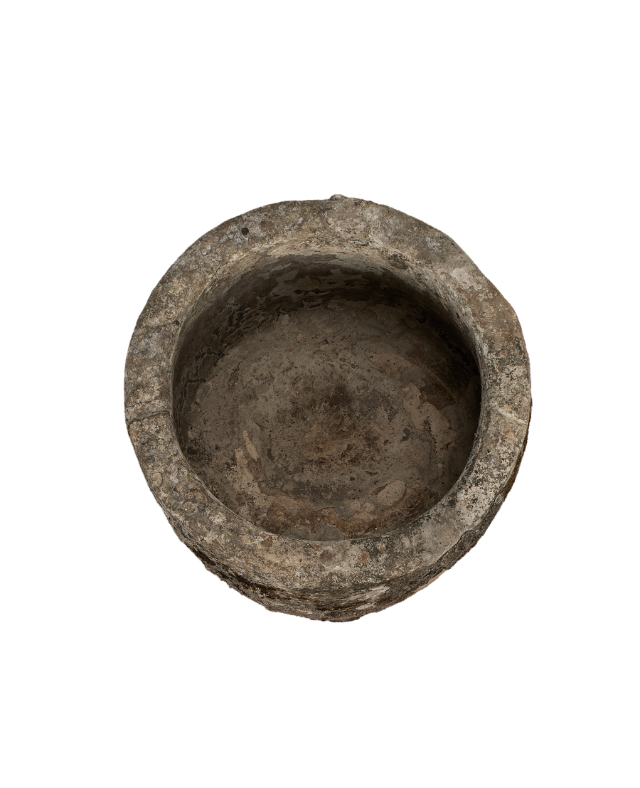 Vintage Indonesian round limestone trough, top-down view showing interior texture and worn rim.