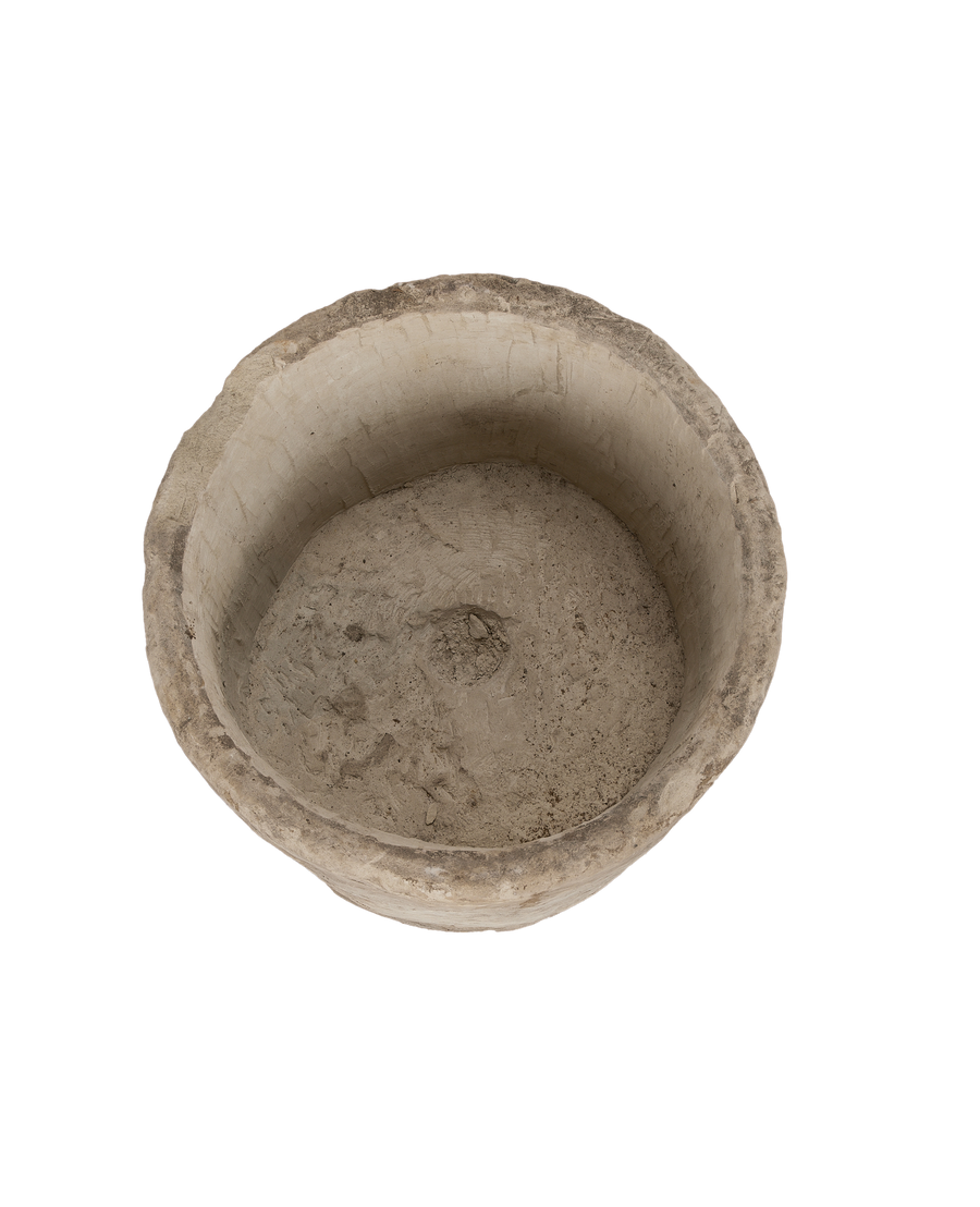 Vintage Indonesian round limestone trough, top-down view showing interior texture and drainage hole.