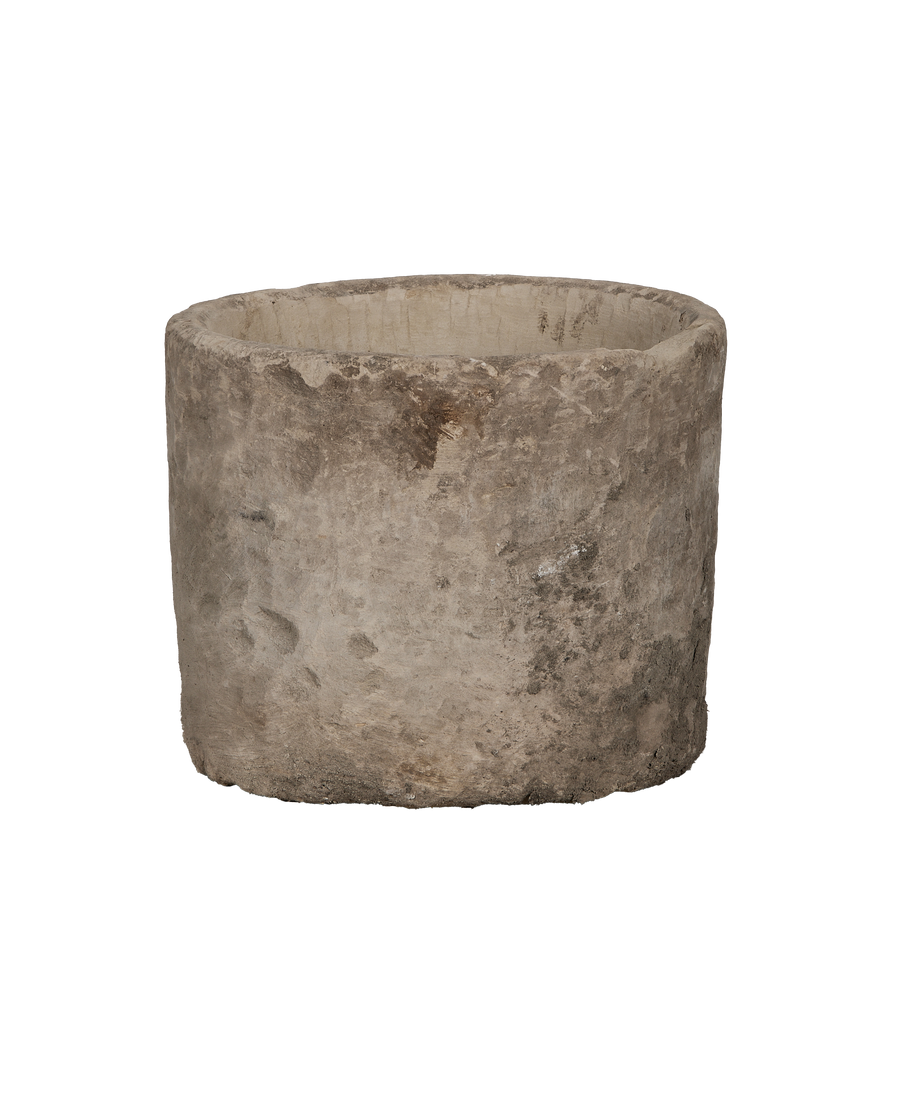 Vintage round Indonesian limestone trough, showing weathered texture from an elevated angle.