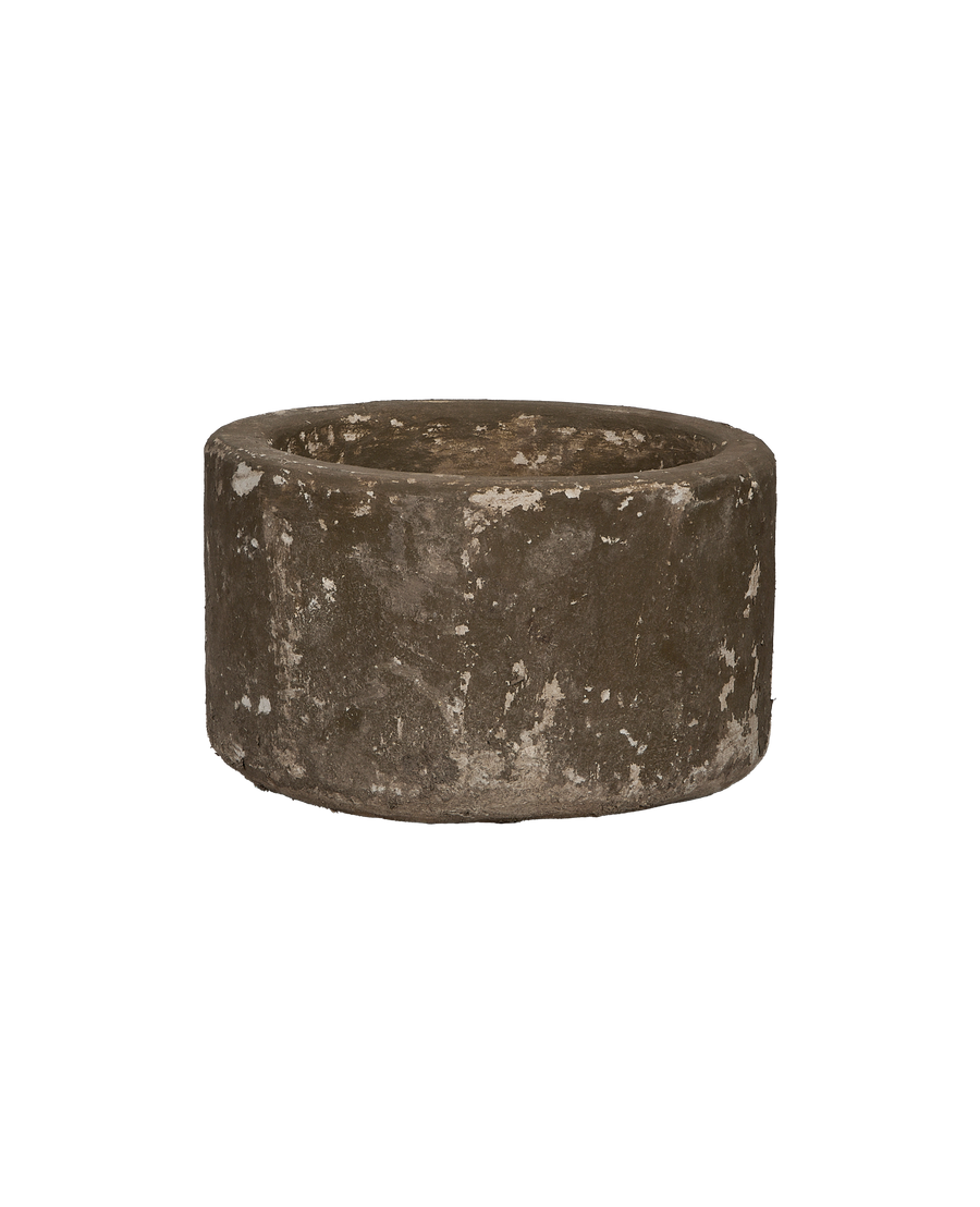 Vintage Indonesian round limestone trough, showing weathered texture and natural imperfections, slightly angled view.