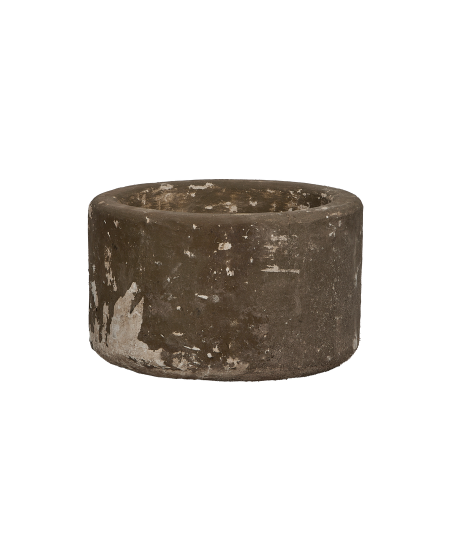 Vintage round limestone trough, aged patina, white remnants, Indonesian antique, side view.