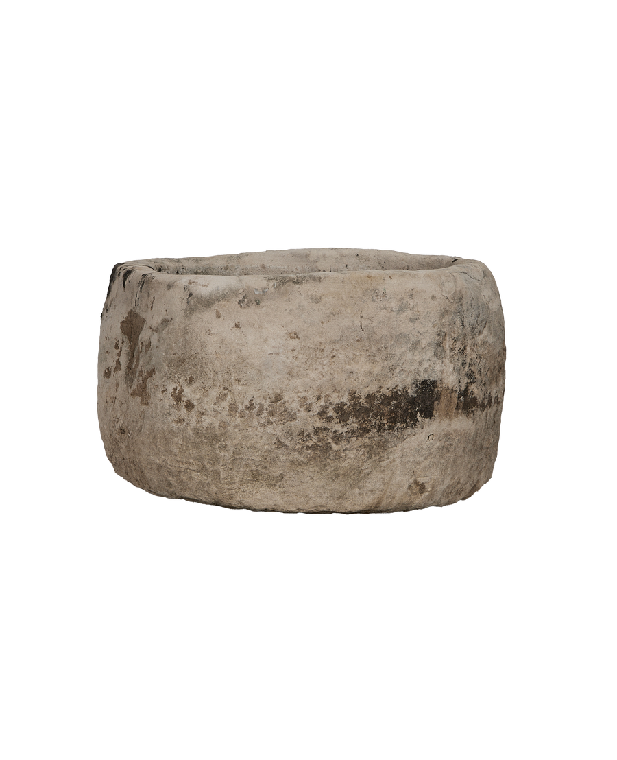 Vintage Indonesian round limestone trough, showing weathered texture from front angle.