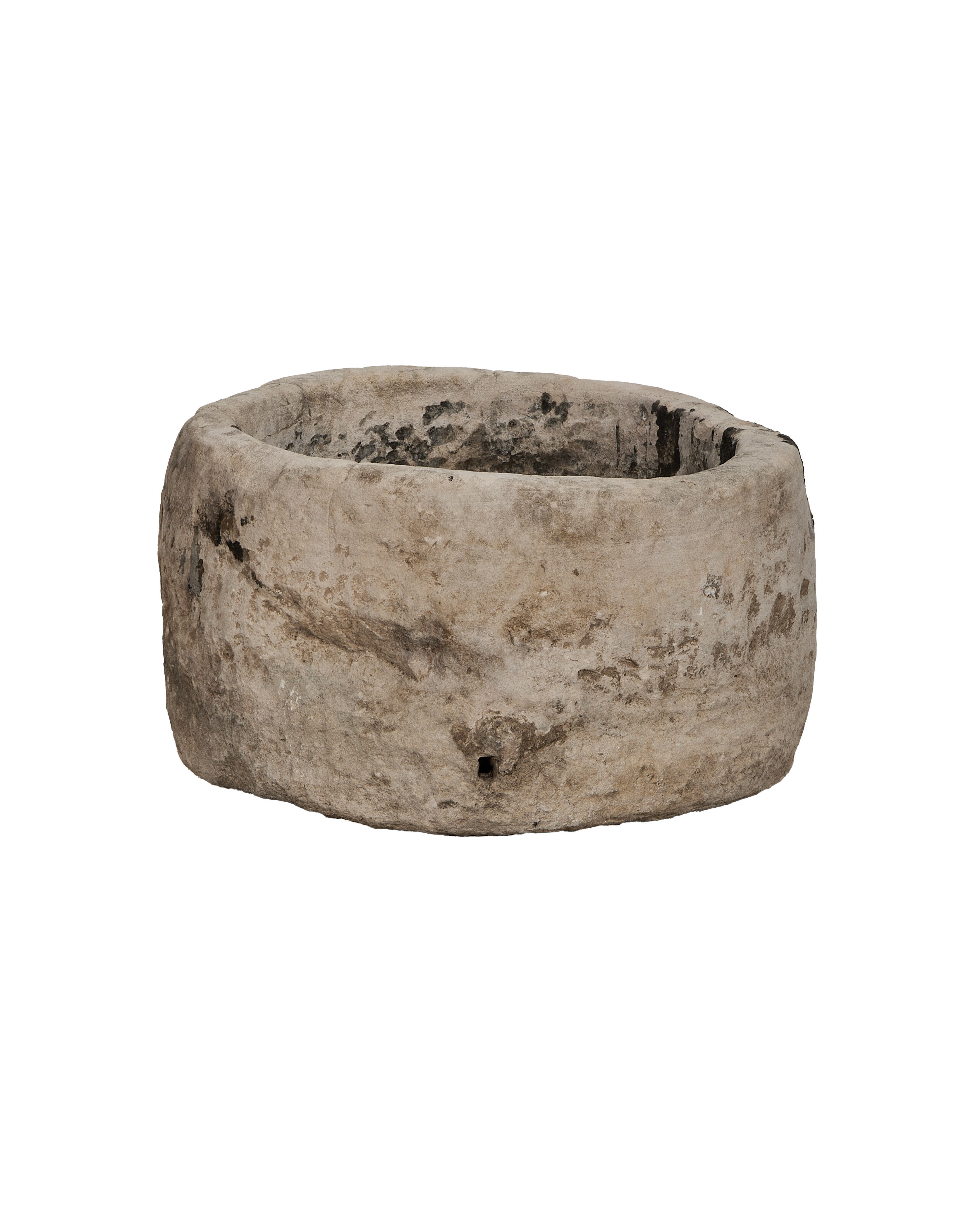 Vintage Indonesian round limestone trough, showing weathered texture and small drainage hole.