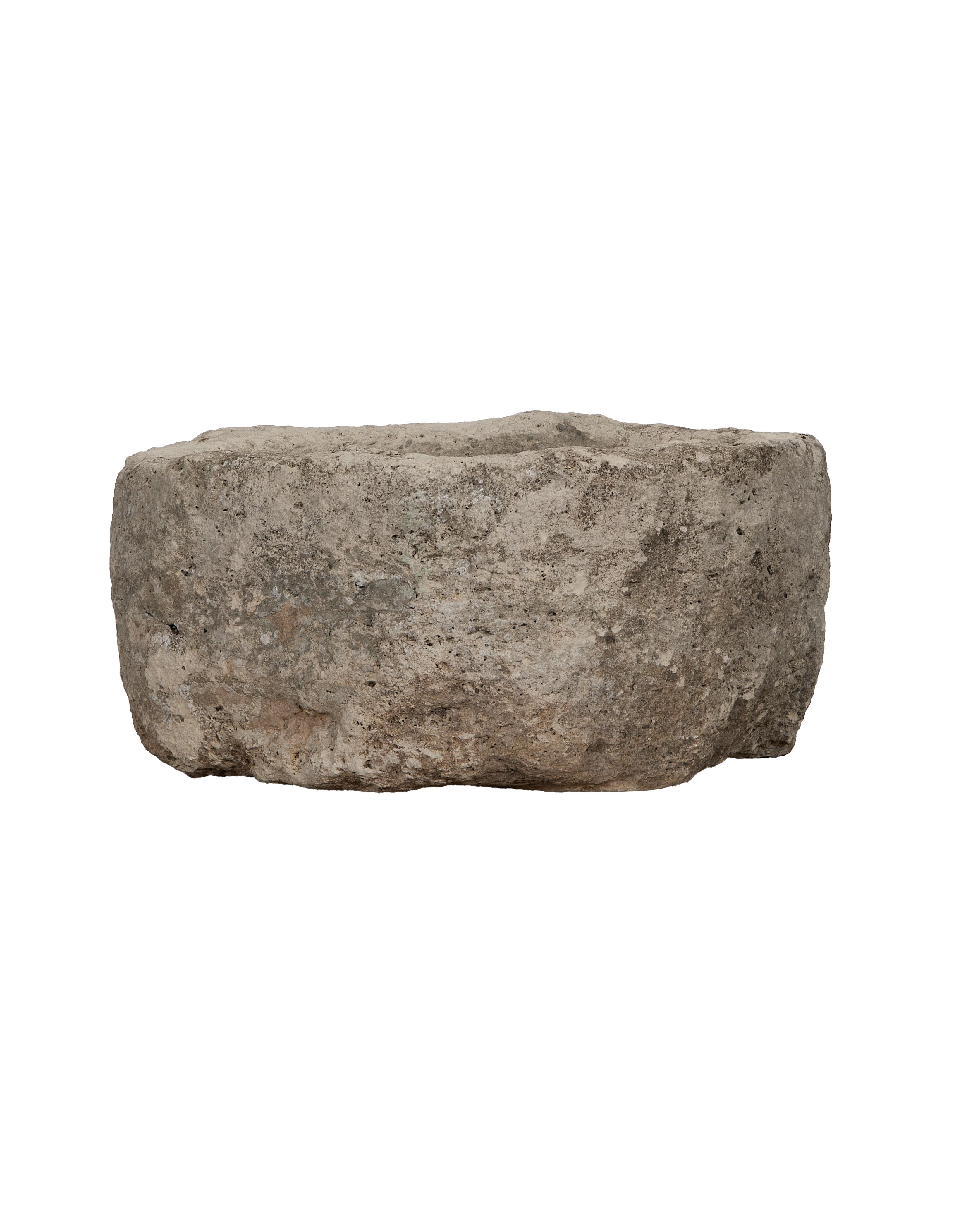 Vintage limestone trough, showing a side view of its rustic, porous texture.