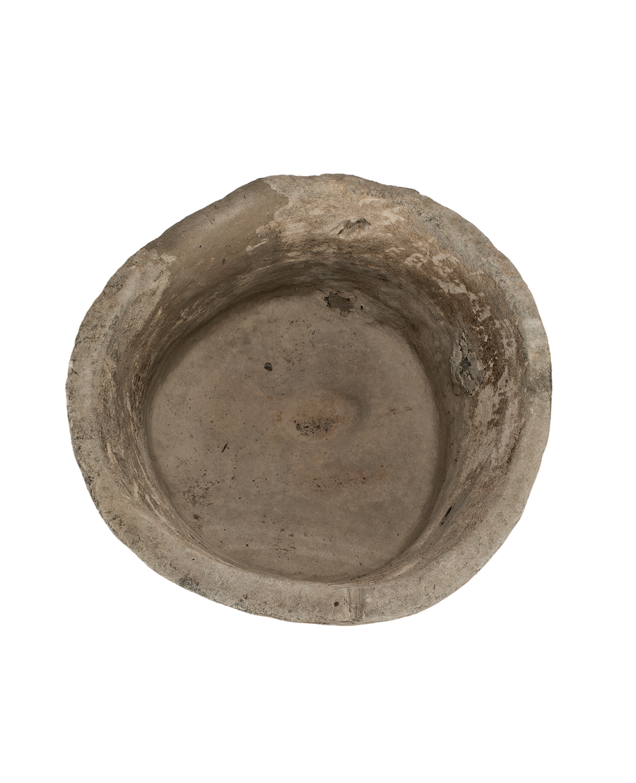 Vintage Indonesian round limestone trough, top-down view showing interior depth and rough texture.