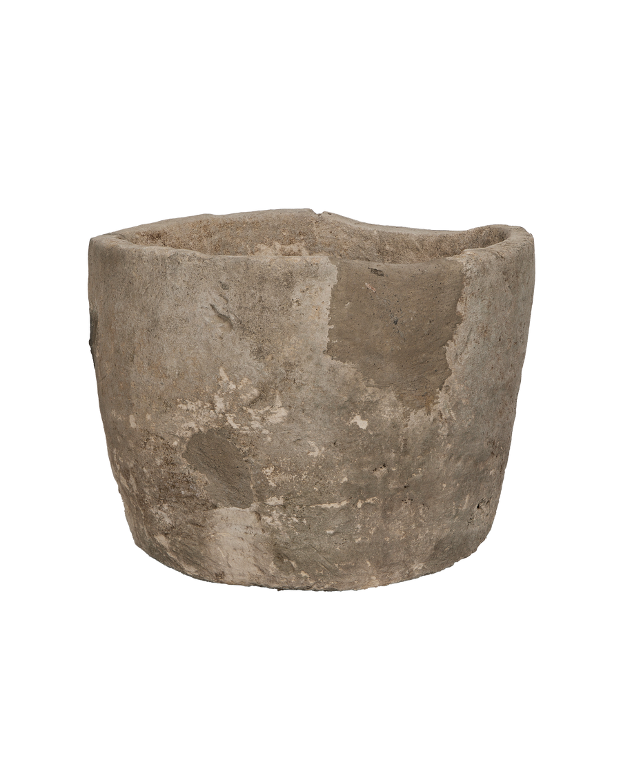 Vintage Indonesian round limestone trough, close-up of textured exterior with variations.