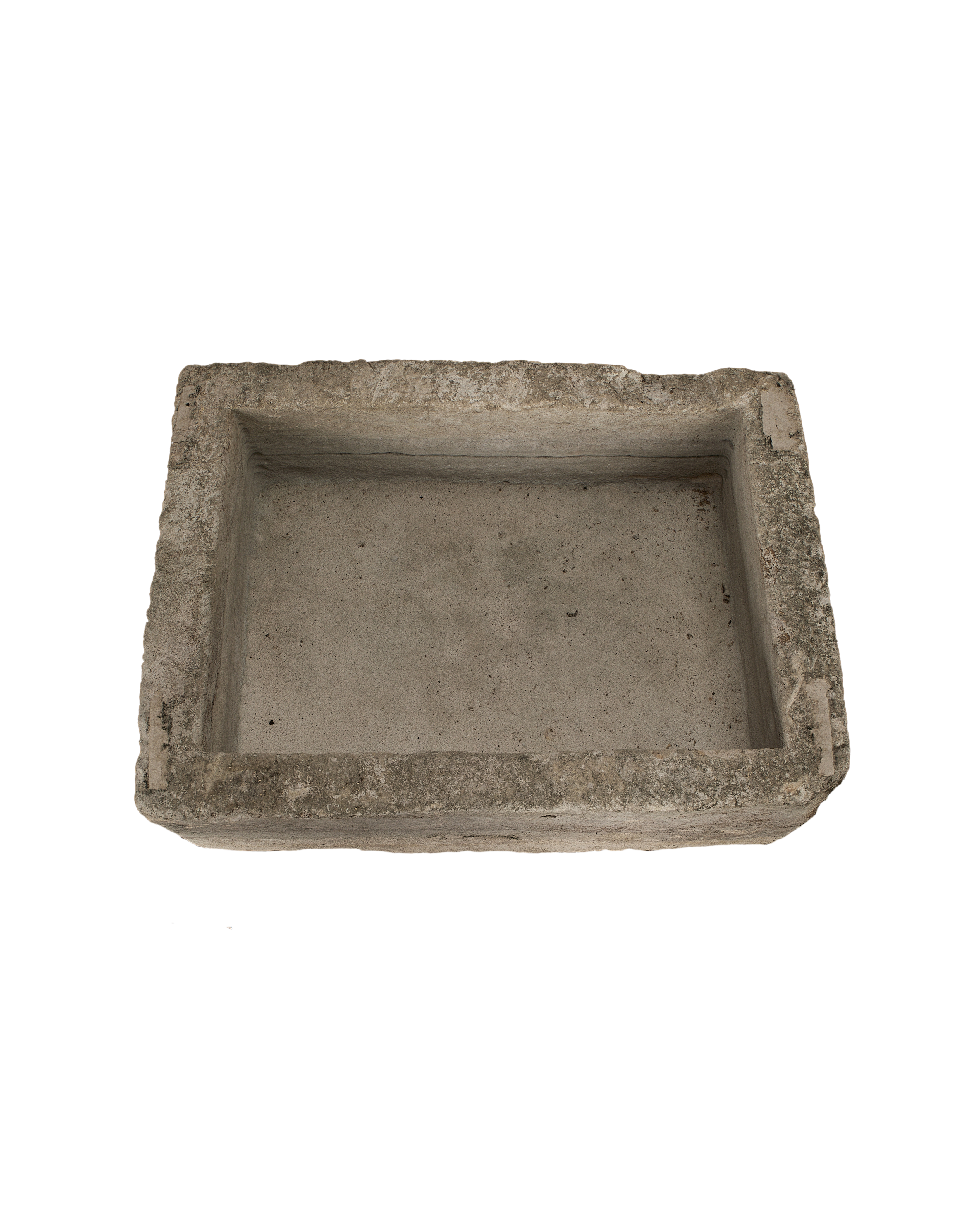 Vintage rectangular limestone trough, showing the weathered texture and depth of the interior.