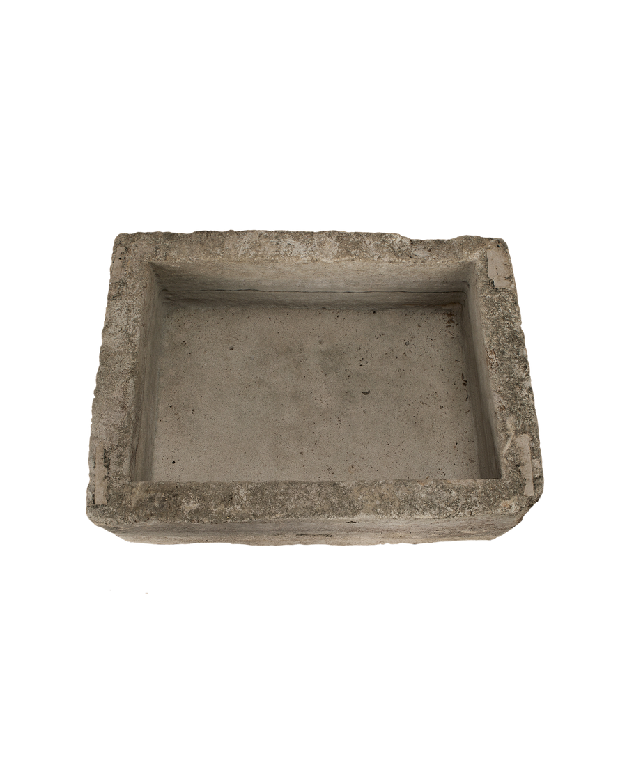 Vintage rectangular limestone trough, showing the weathered texture and depth of the interior.