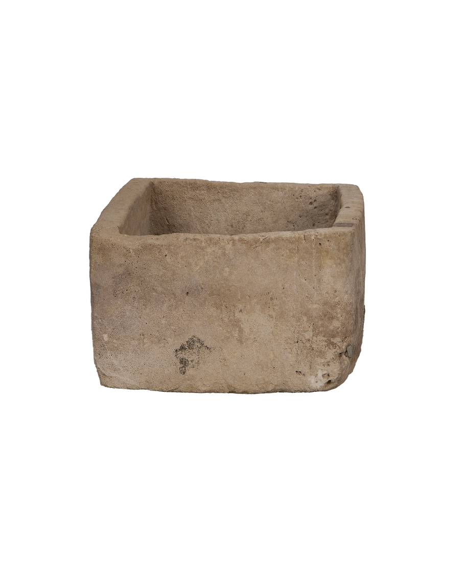 Vintage rectangular limestone trough, showing rough-cut bottom edge and weathered surface texture.