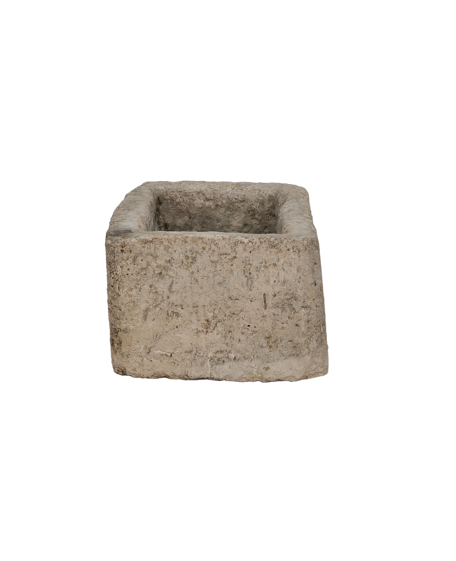 Vintage rectangular limestone trough, showing the rustic, weathered, textured surface from a slightly top-down angle.