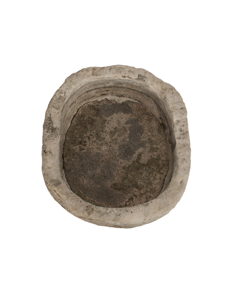 Vintage limestone trough from Indonesia, top view showing weathered, oblong interior.