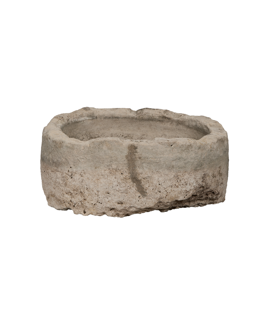 Vintage Indonesian oblong limestone trough viewed from the side, showcasing its weathered, rustic texture.