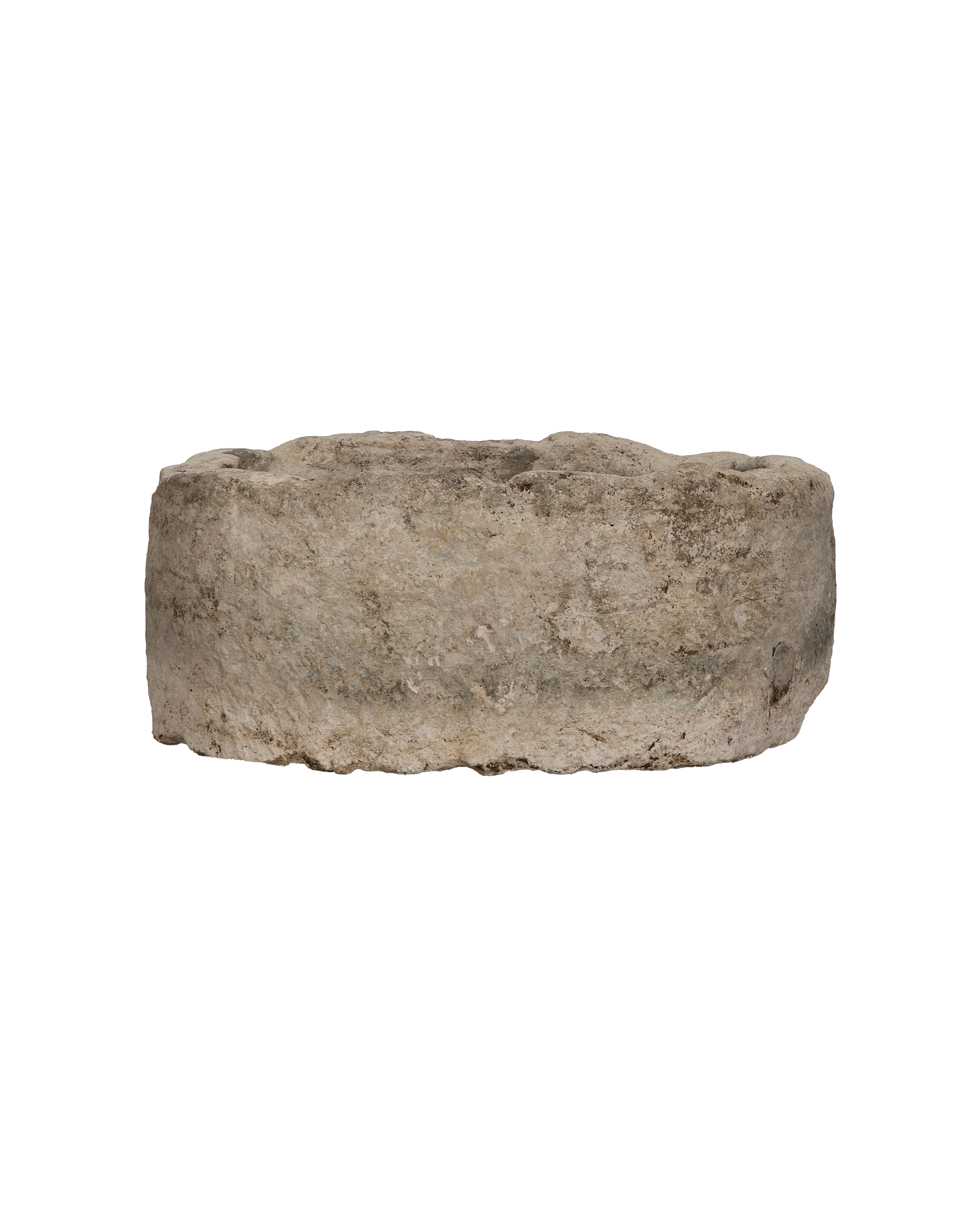 Vintage Indonesian oblong limestone trough, weathered surface texture close-up.